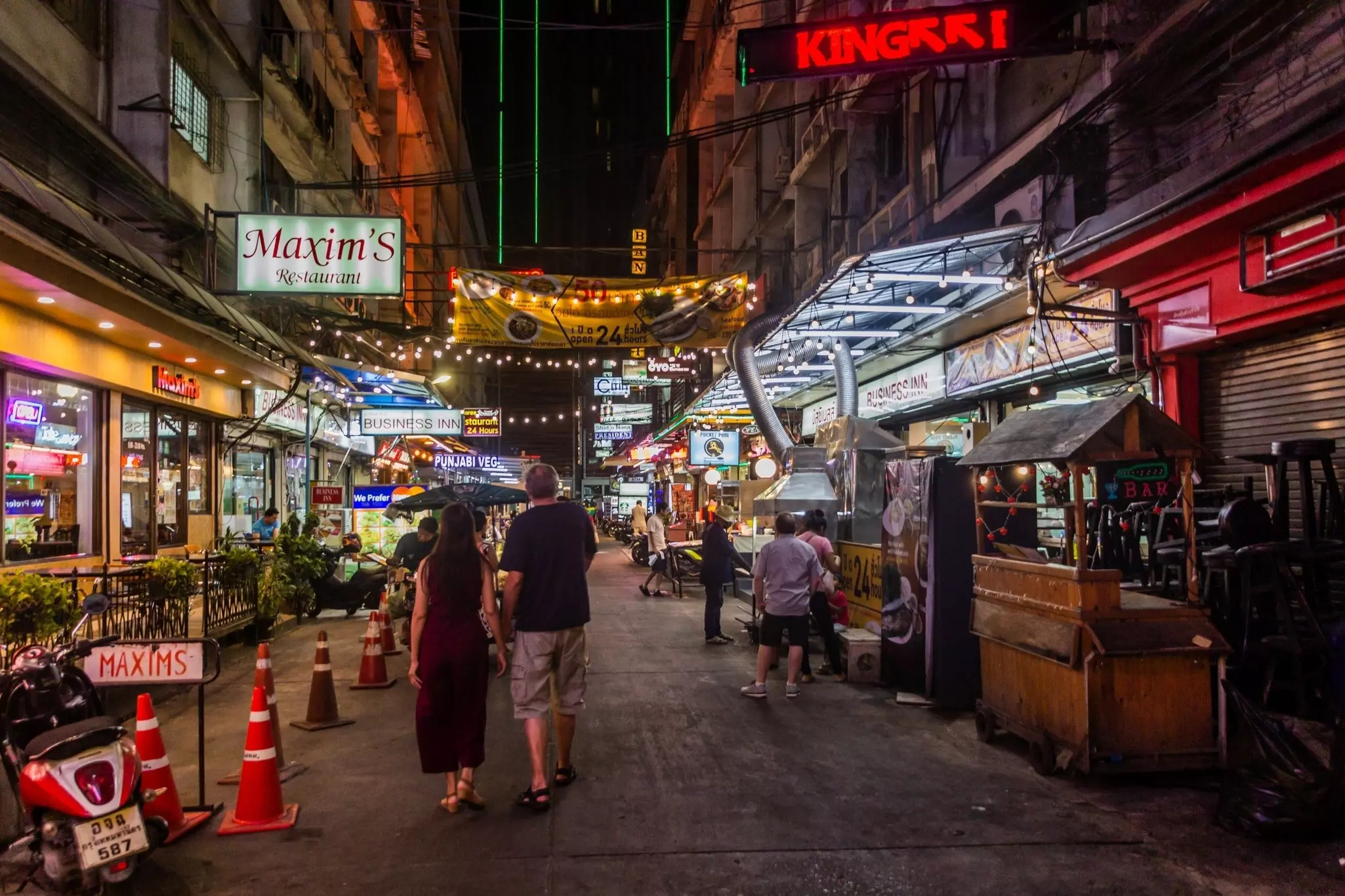 Shops and restaurants after dark around Sukhumvit Rd in Bangkok.