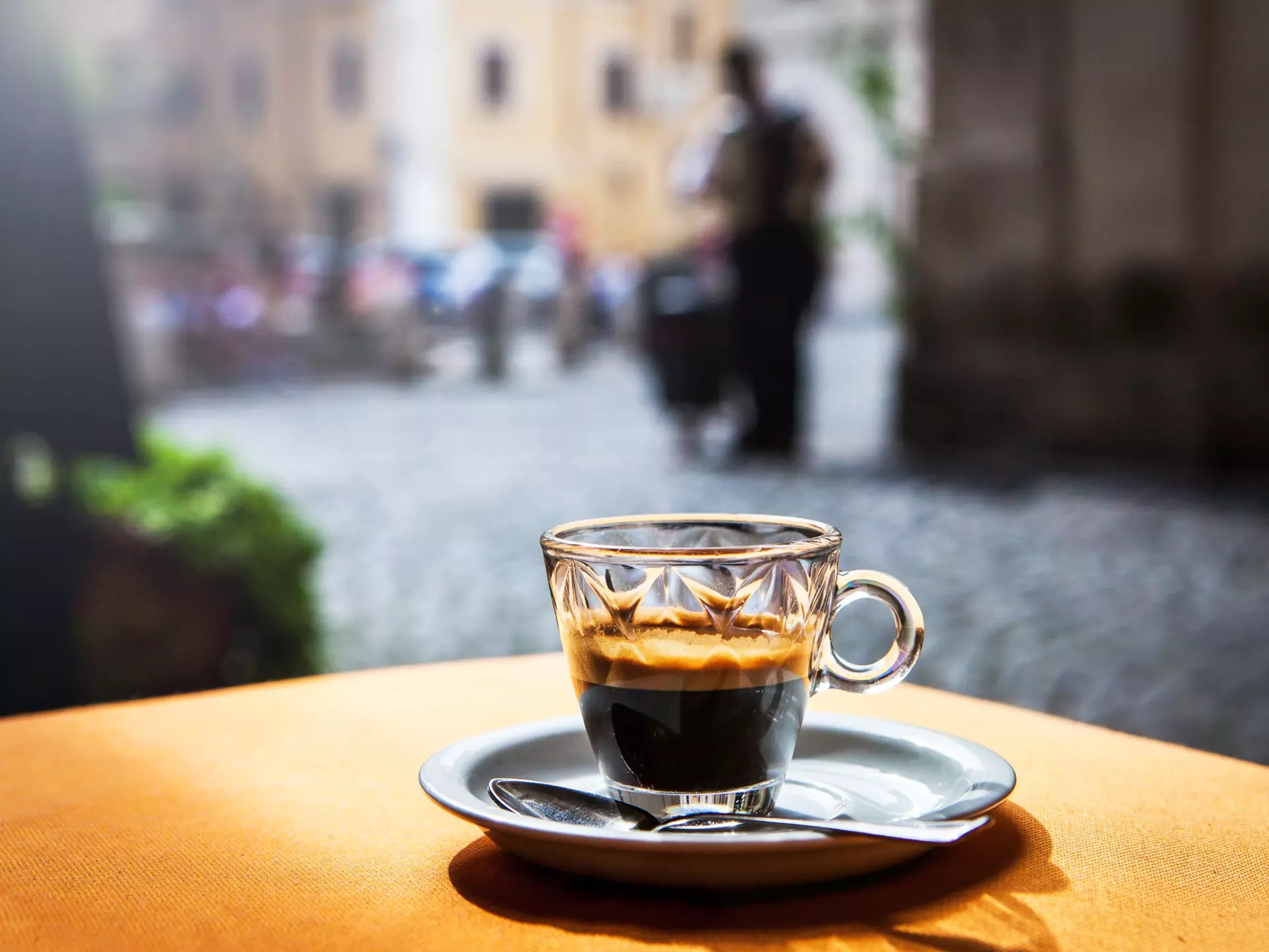 Cup of hot black coffee espresso on a table in a cafe