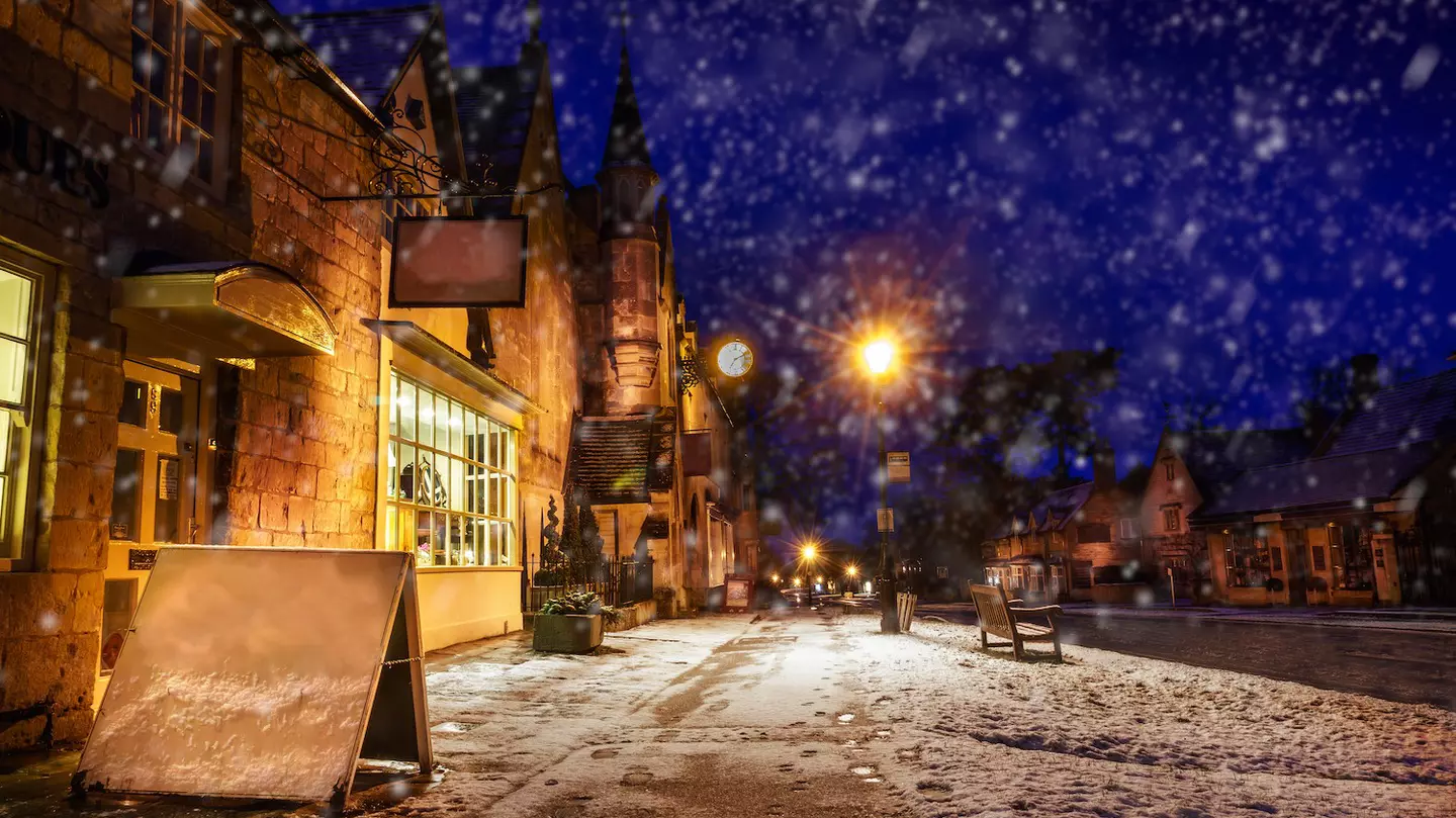 High Street at night during light snowfall, Broadway, Gloucestershire, the Cotswolds, England, United Kingdom