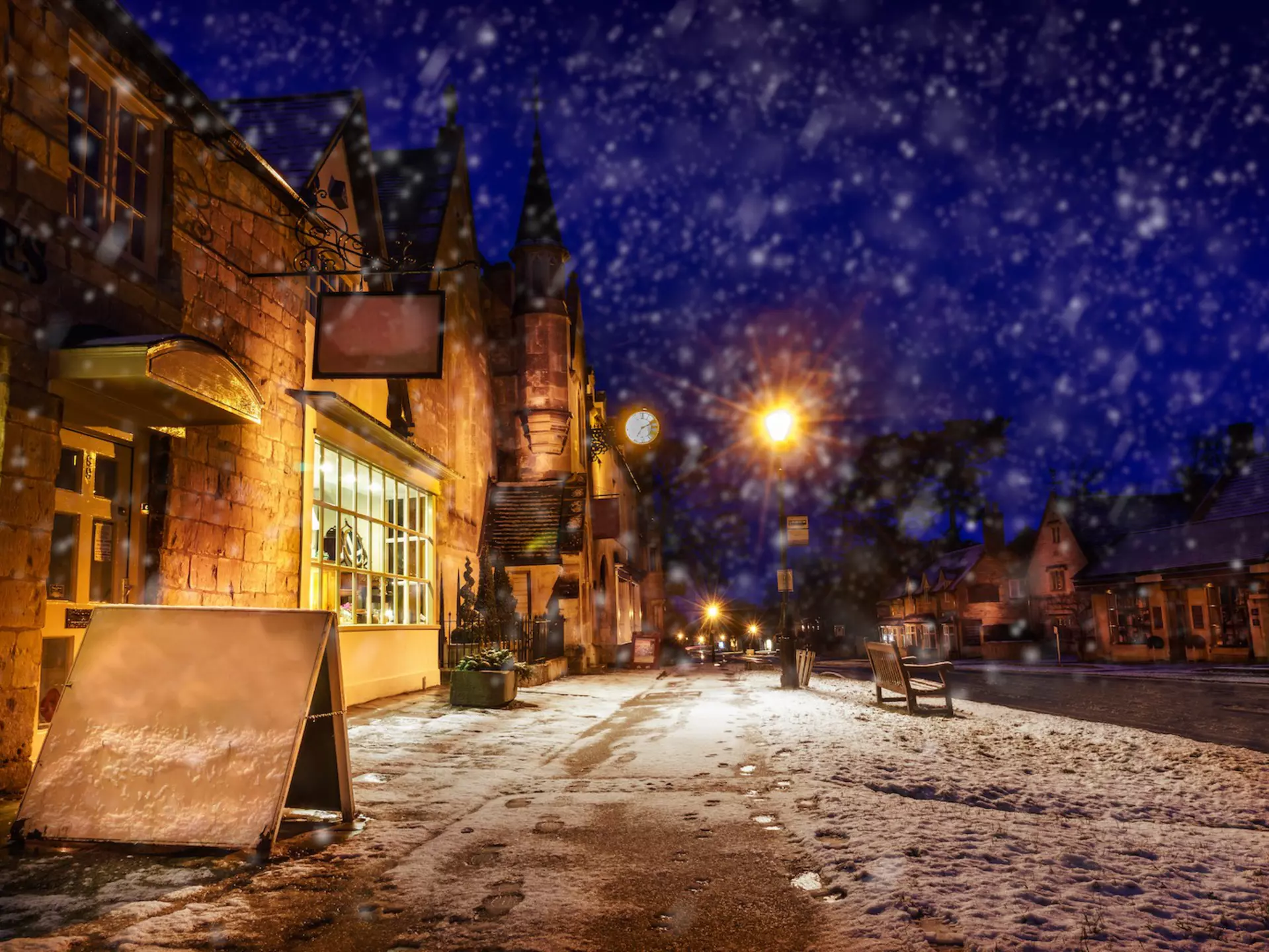 High Street at night during light snowfall, Broadway, Gloucestershire, the Cotswolds, England, United Kingdom