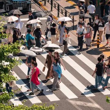 People walking on crosswalk Tokyo city street. Summer season lifestyle in Tokyo, Japan