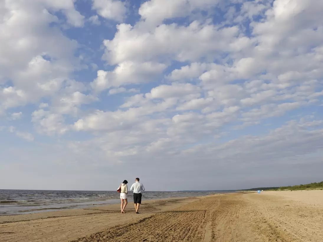 Couple walking down Jūrmala beach