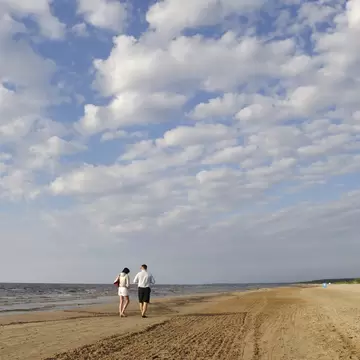Couple walking down Jūrmala beach