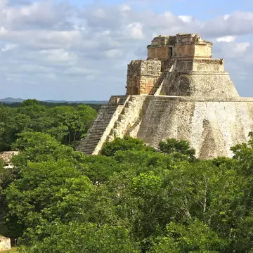 The Yucatán is dotted with Maya cities that showcase incredible architecture like the Temple of the Magician at Uxmal. P. Lubas / Getty Images