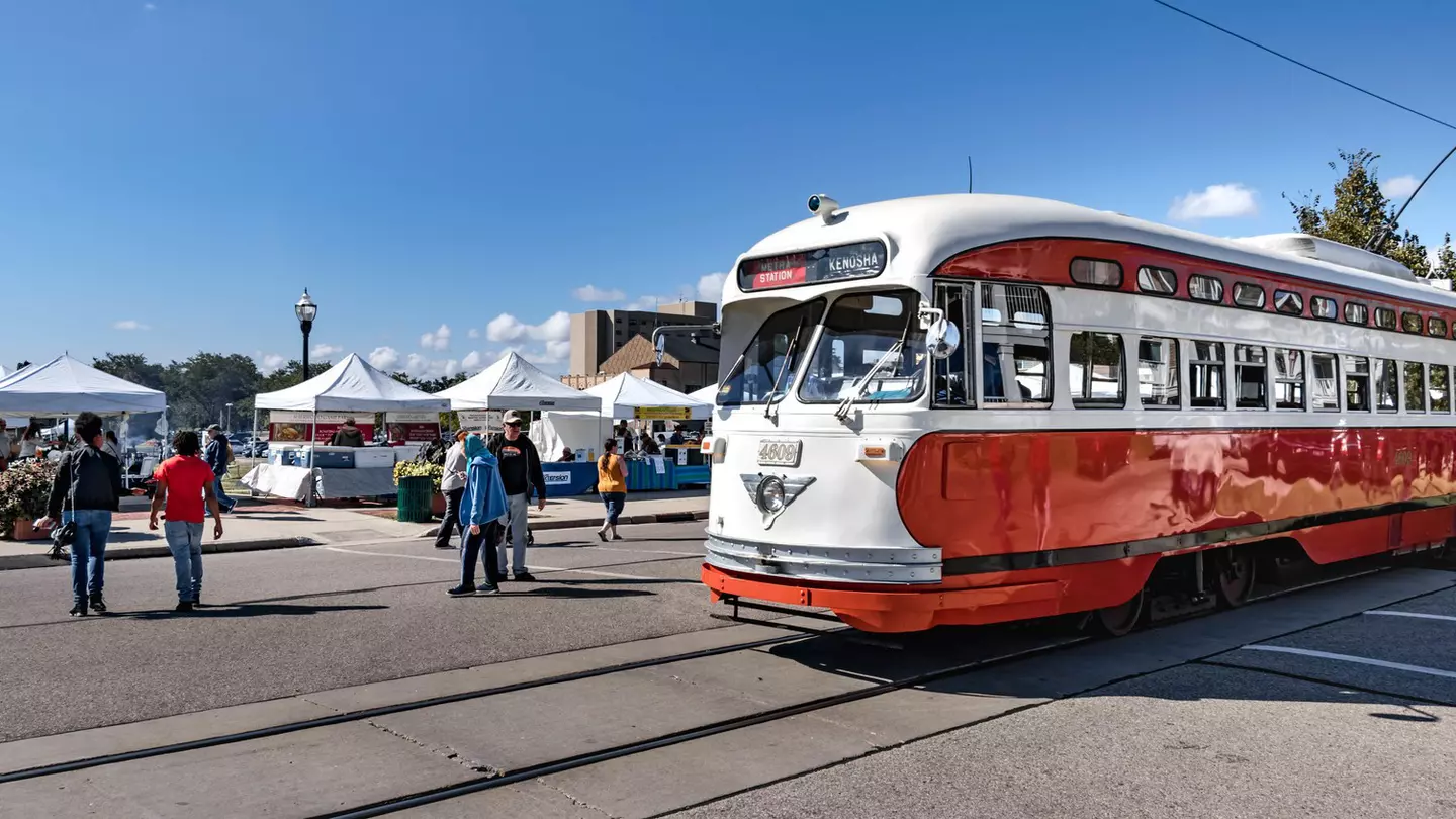 An electric streetcar going by Kenosha HarborMarket