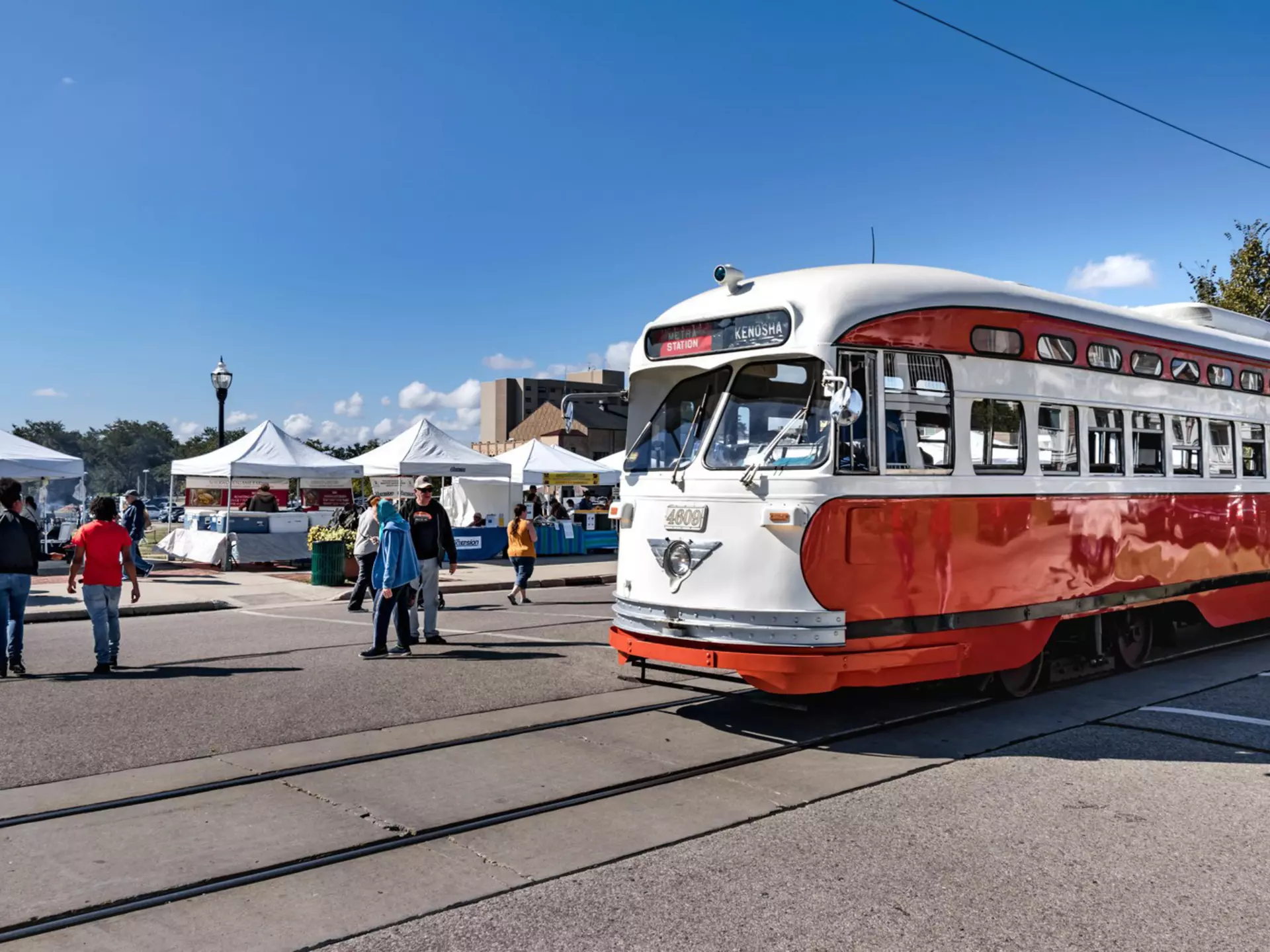 An electric streetcar going by Kenosha HarborMarket