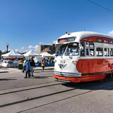 An electric streetcar going by Kenosha HarborMarket