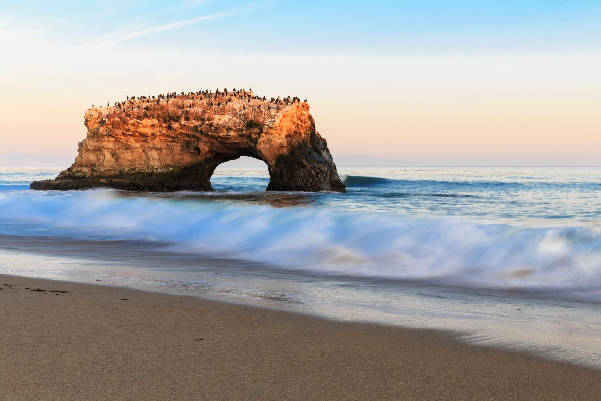 USA, California, Santa Cruz County, Big Sur, Pacific Ocean, Natural Bridges State Beach, Natural Bridge in the evening light