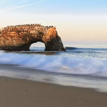USA, California, Santa Cruz County, Big Sur, Pacific Ocean, Natural Bridges State Beach, Natural Bridge in the evening light