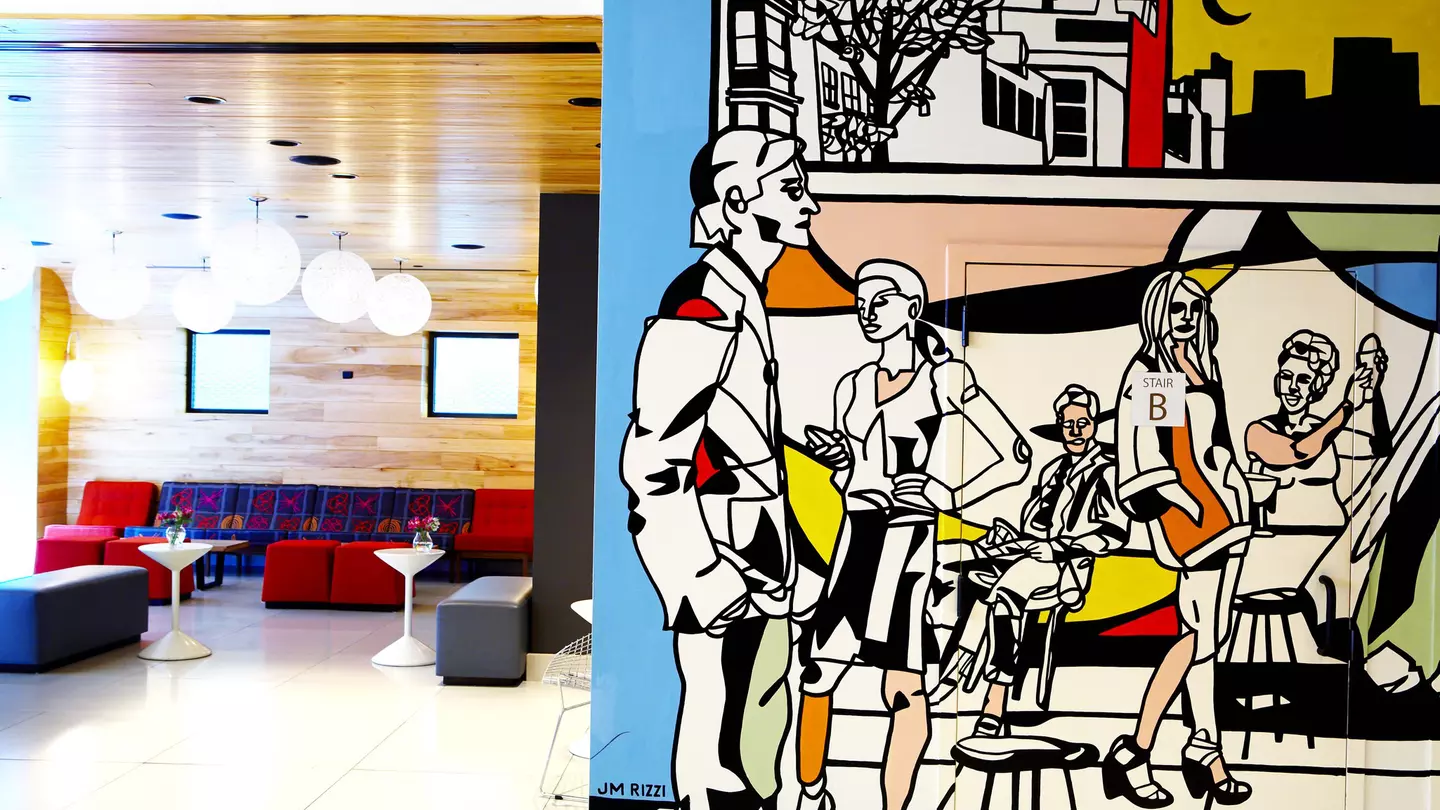 A picture of the living room of the pod with the benches that can convert into beds