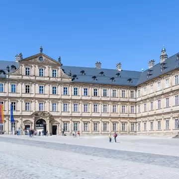 Visitors walk around Neue Residenz in Bamberg, Germany.