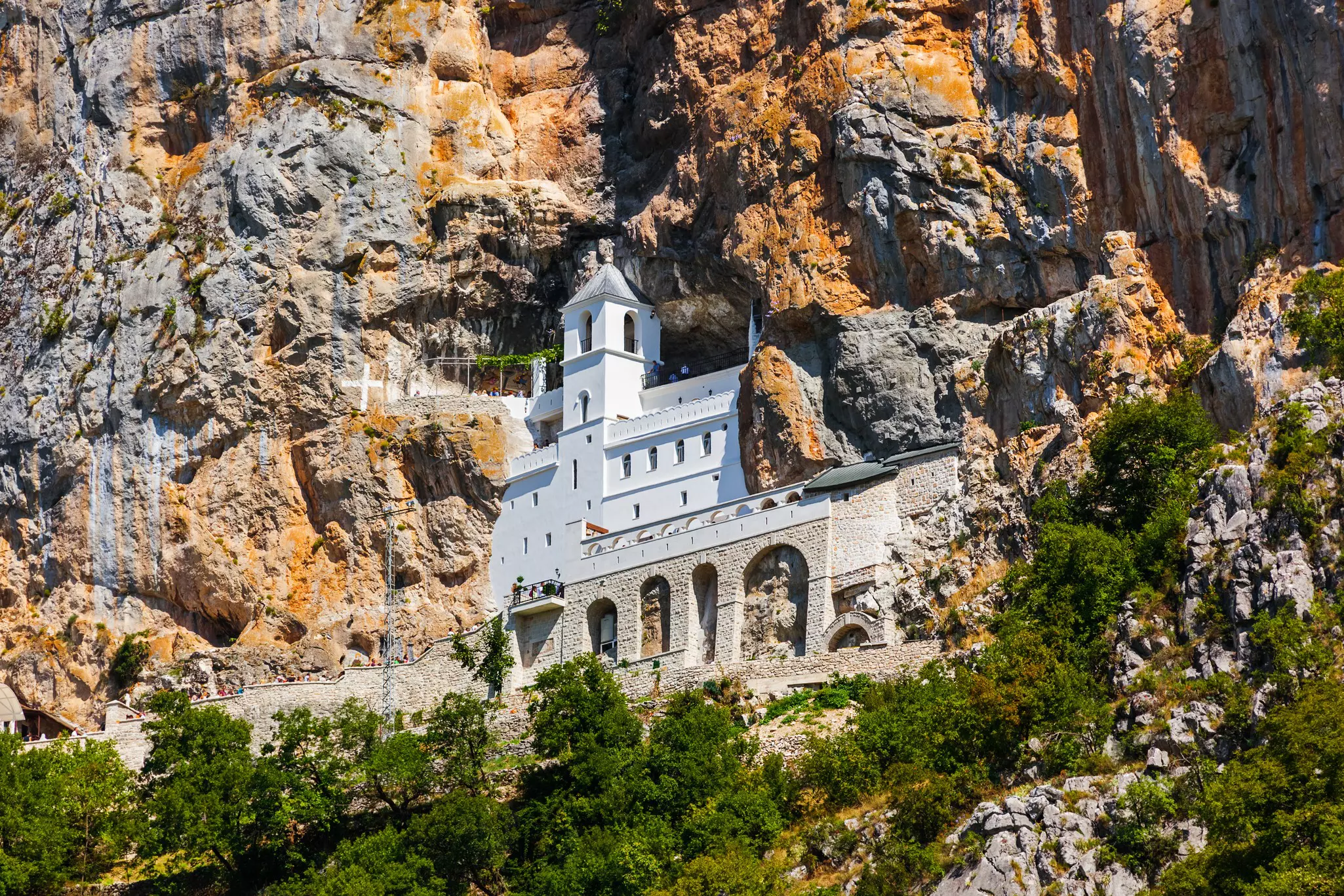 The historic Ostrog Monastery, set into a rocky cliff face in Montenegro.