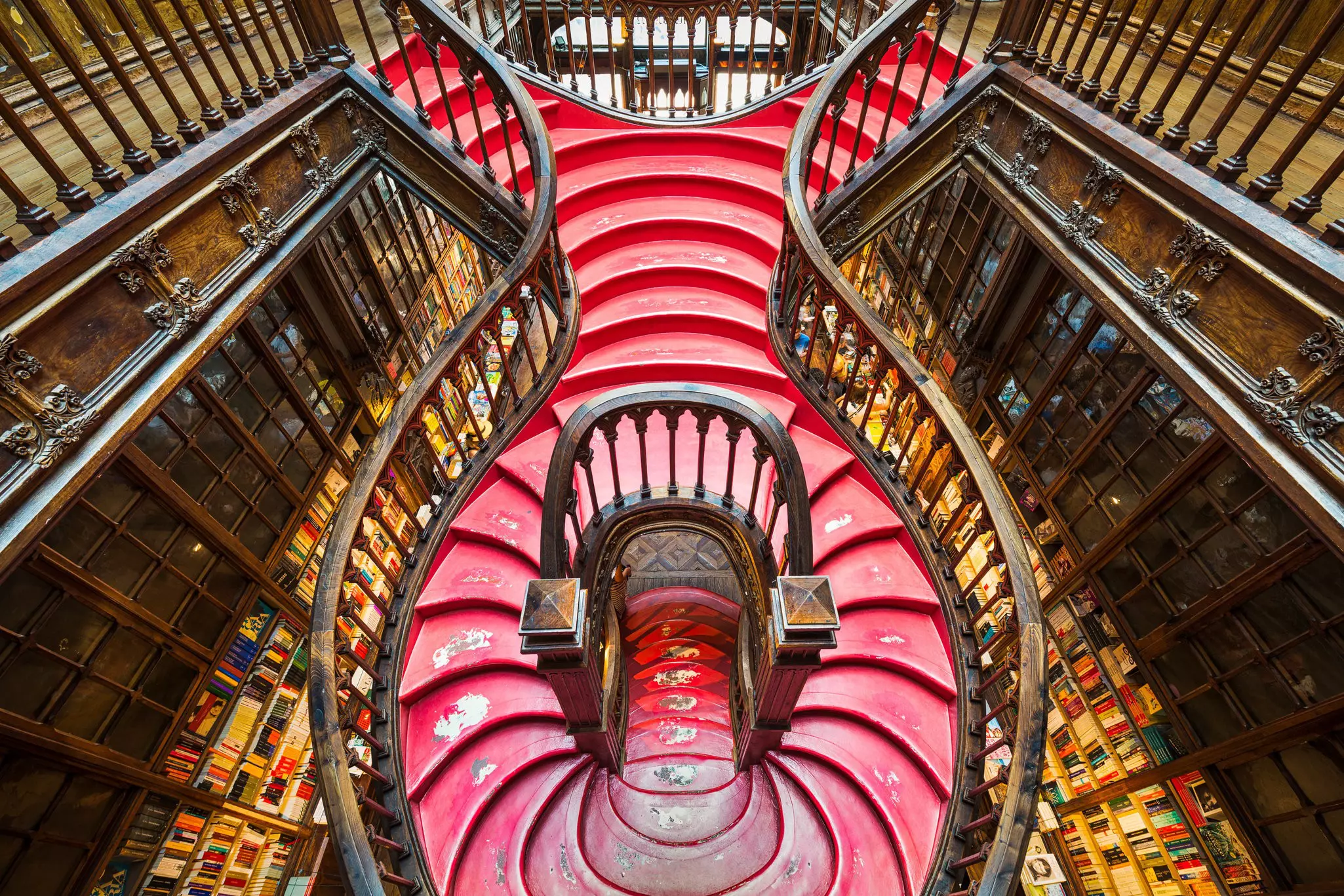 For a glimpse of J.K. Rowling's inspiration and a Diagon Alley experience, head to the Livraria Lello in Porto, Portugal. Mapics / Shutterstock