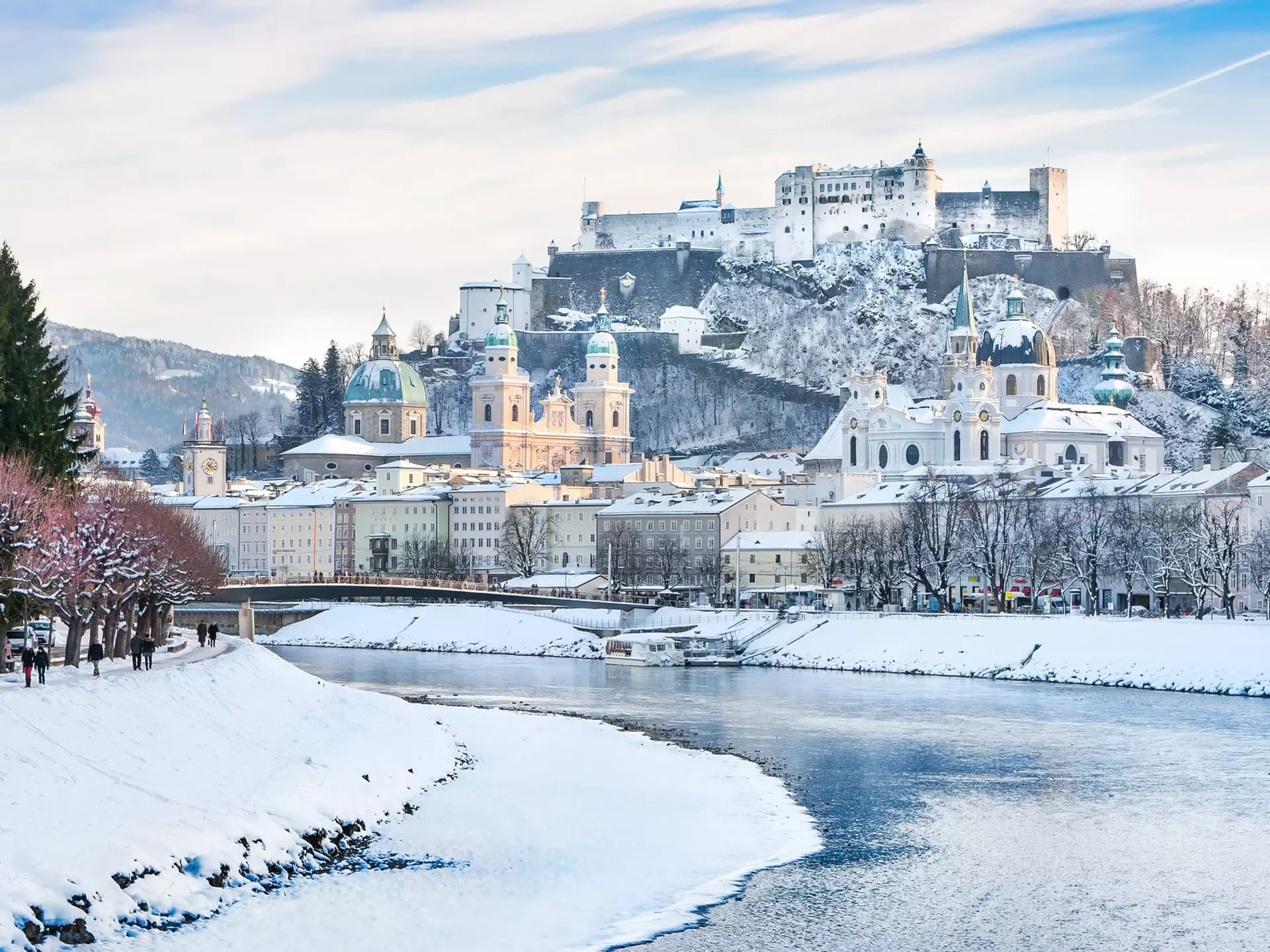 A wintry Salzburg skyline with Festung Hohensalzburg and the Salzach River. canadastock/Shutterstock