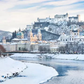 A wintry Salzburg skyline with Festung Hohensalzburg and the Salzach River. canadastock/Shutterstock