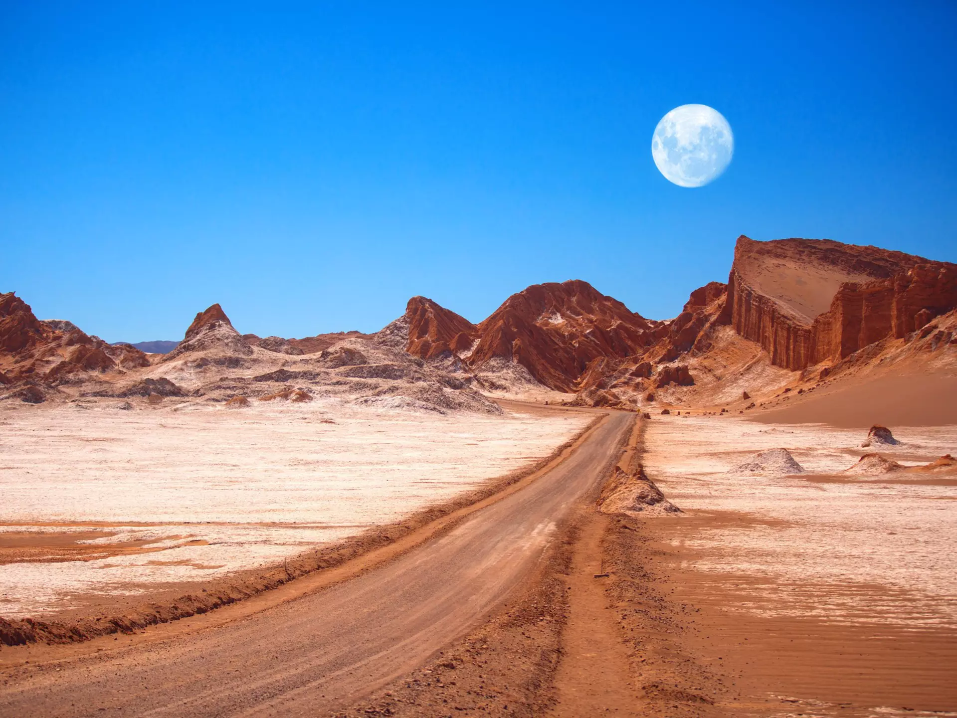 The moon rises above the amphitheatre, a geological formation in Moon Valley..