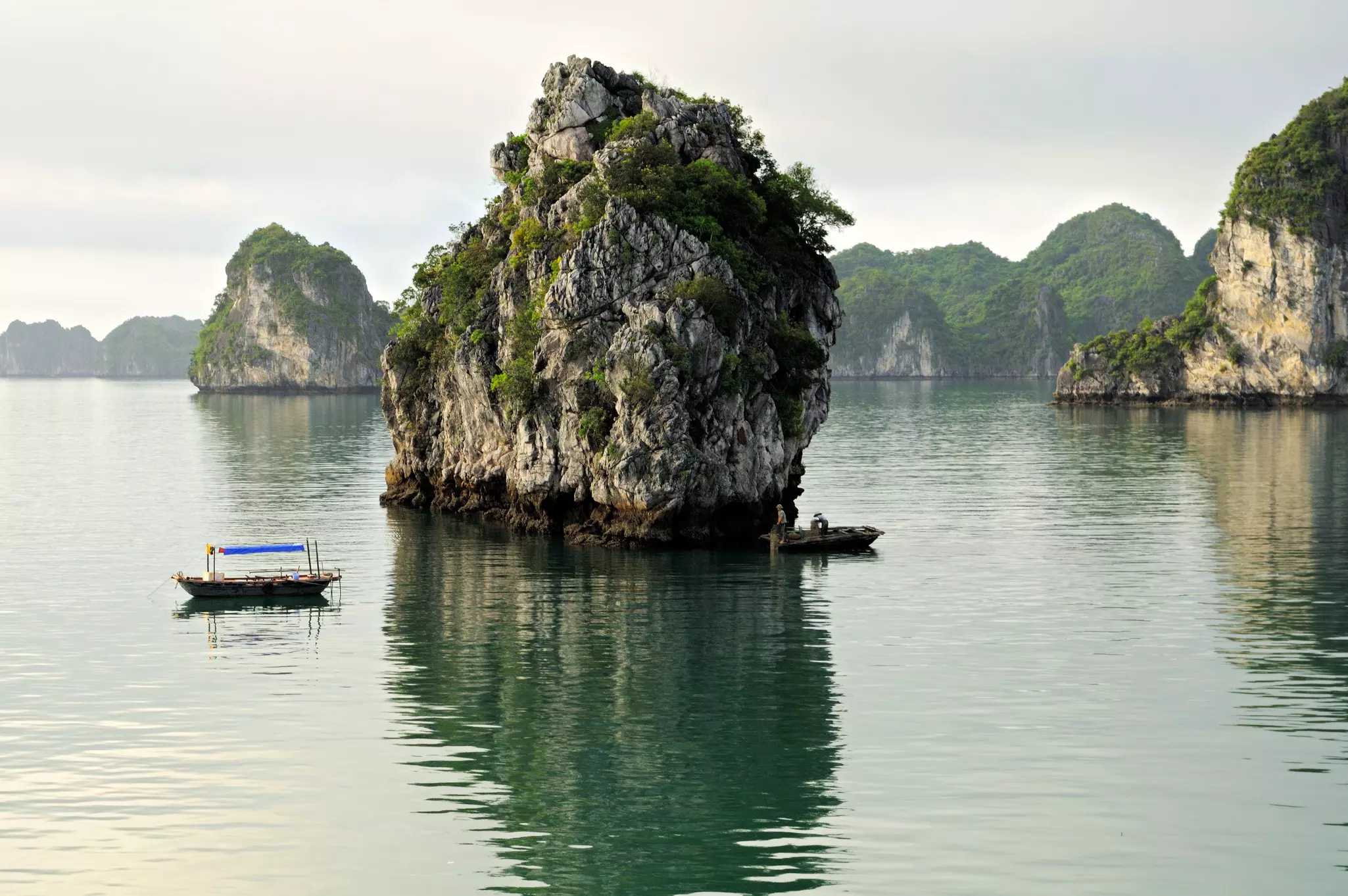 Small boats near a rocky islets in a sheltered bay.