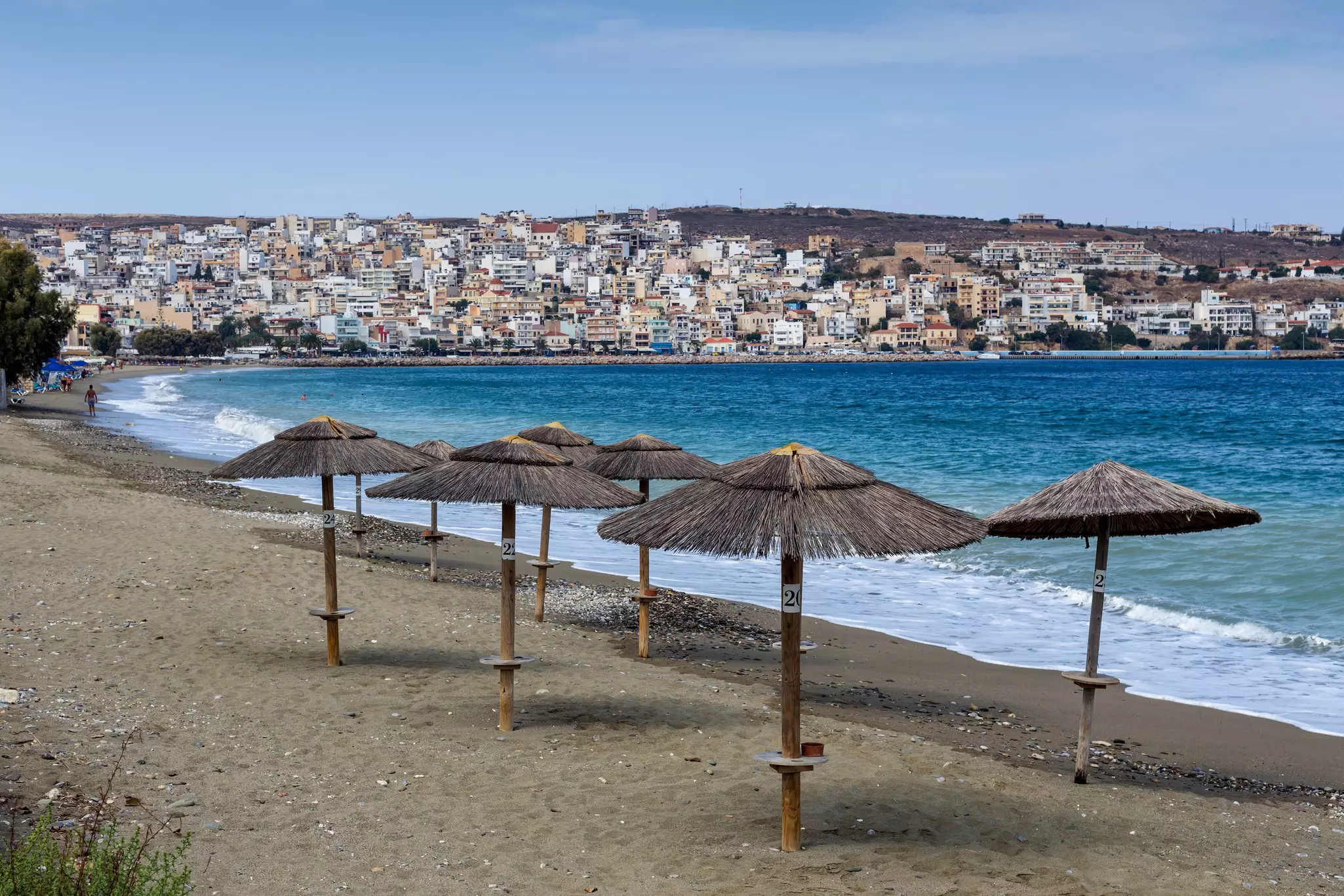 An empty beach with sunshades near the Cretan town of Sitia.