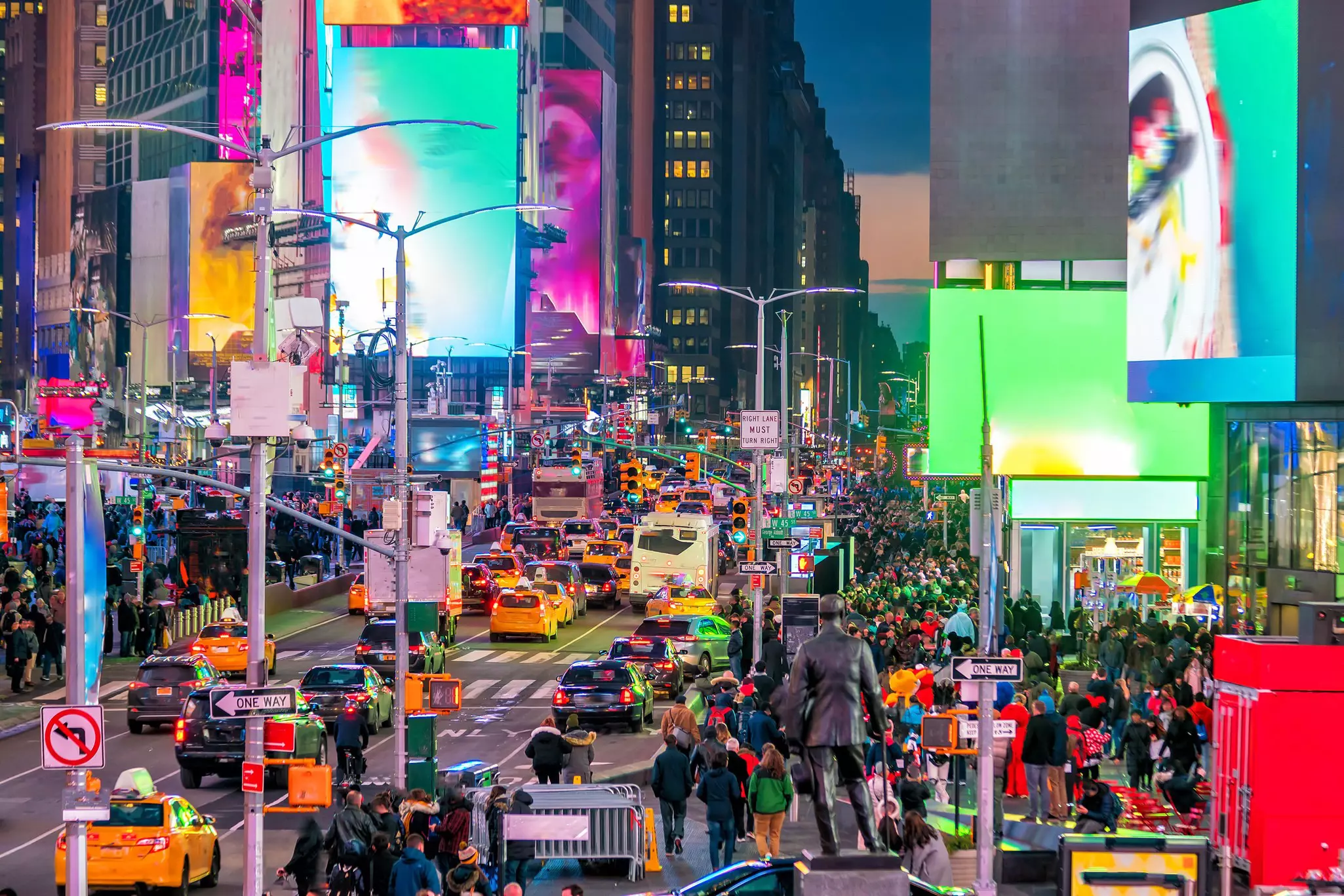 Times Square crowded with visitors and neon signs at night