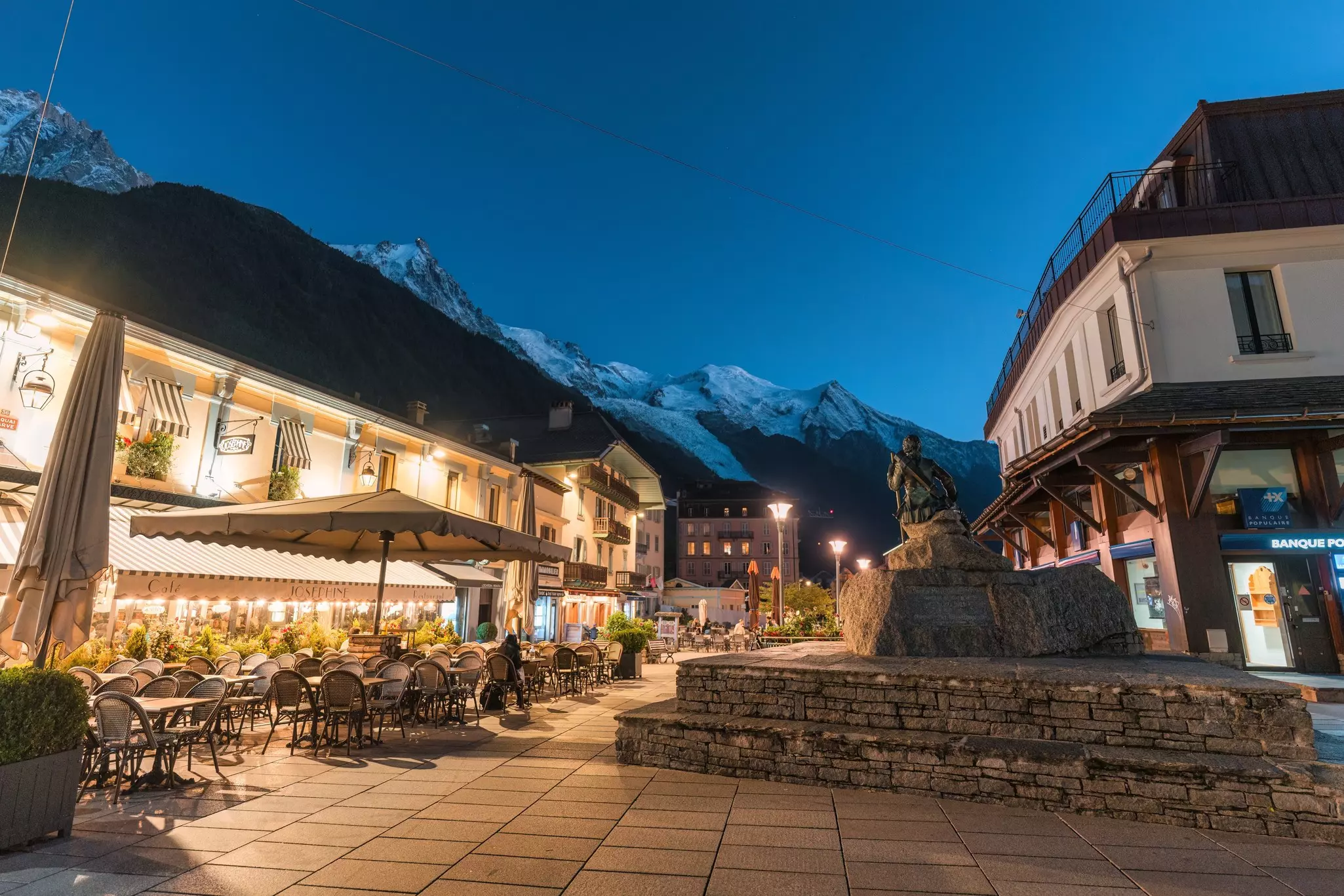 Beautiful night scene of Ski resort Chamonix ski resort town with monument and illuminated restaurant among the Mont Blanc massif in French Alps