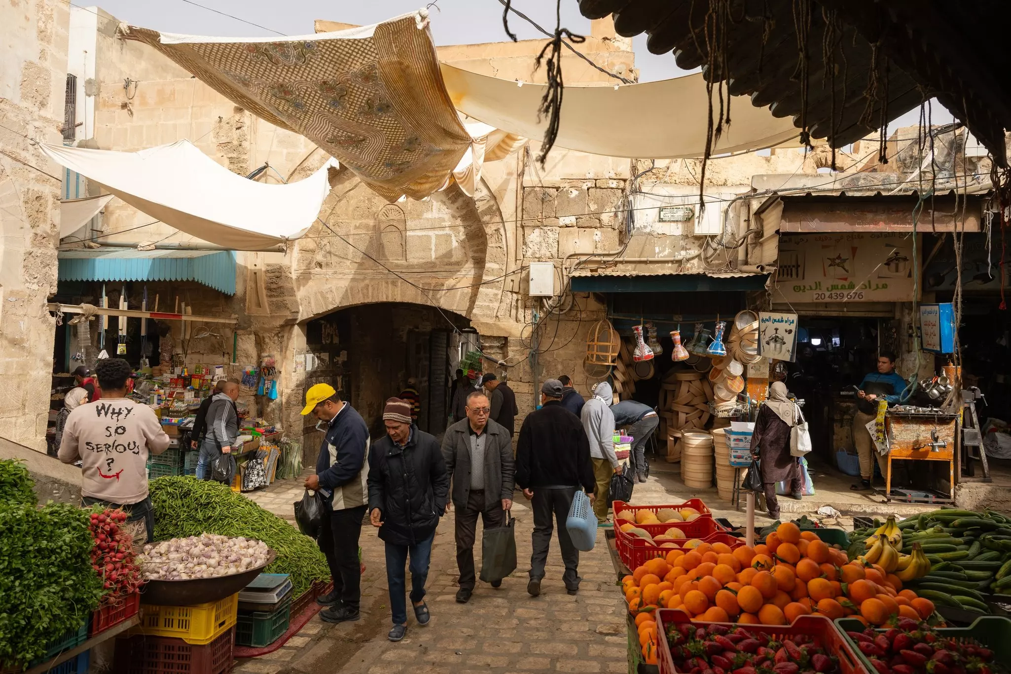 A busy vegetable market inside a medina