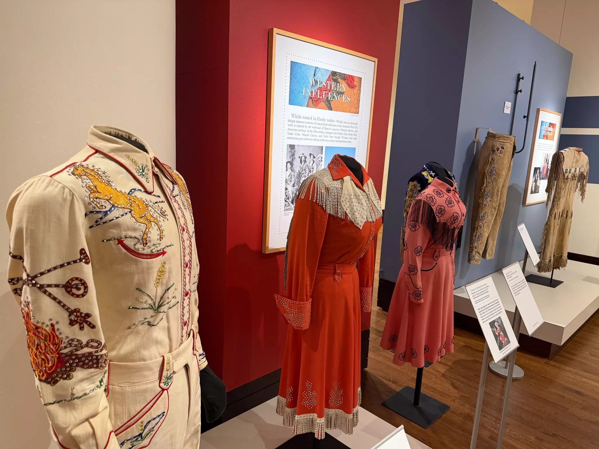A collection of Western-inspired clothing on display at a museum