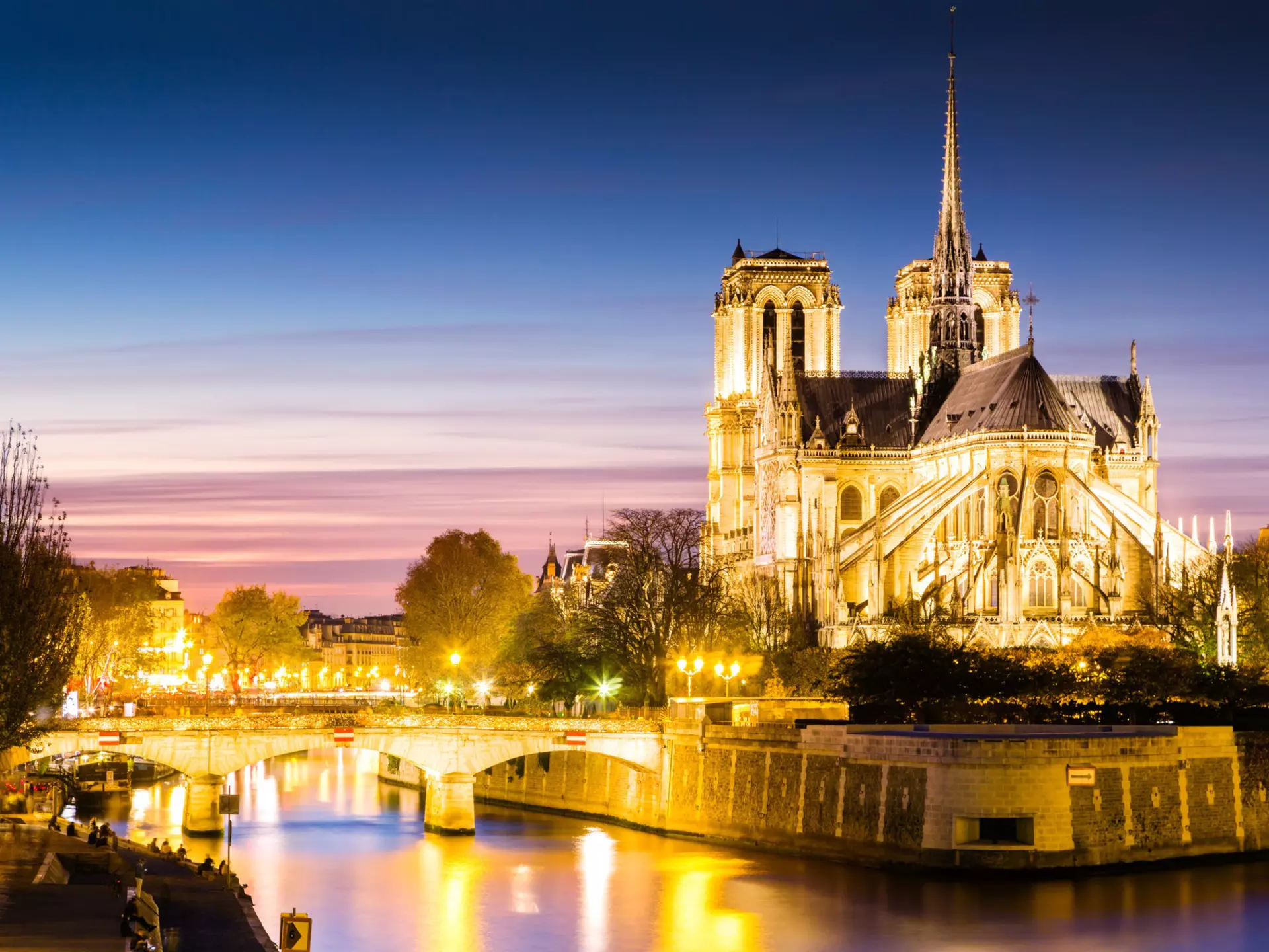 Notre Dame cathedral lit up at dusk.
601762967
Architecture, Cathedral, City, Notre Dame de Paris, iconic, Paris - France, French Culture, Religion, Illuminated, Paris, Building Exterior, Island, Dusk, Capital Cities, Seine River, Photography, Icon, 2015, Reflection, France, Outdoors, Steeple, Arch Bridge, No People, Embankment, Travel Destinations, Horizontal, Moody Sky, Famous Place, International Landmark, Color Image, Gothic Style, Ile-de-France