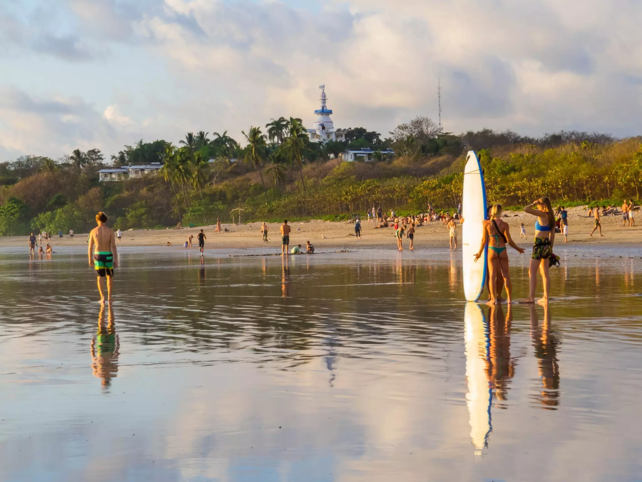 Beach-goers gather along the shore at Playa Guiones.