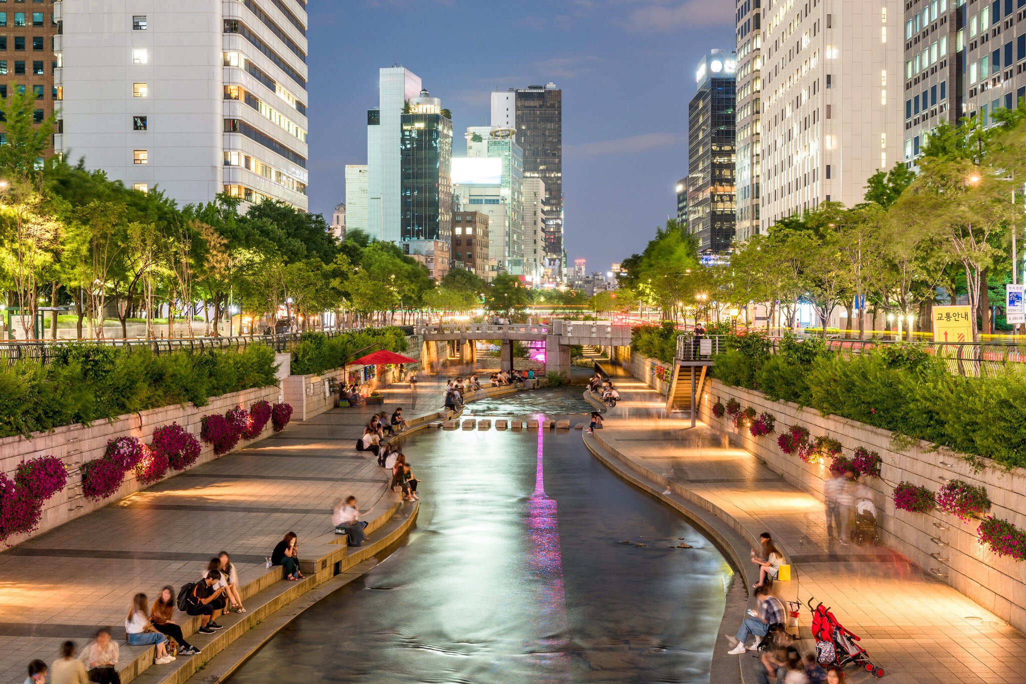 People relaxing by Cheong-Gyecheon stream in the centre of Seoul on a summer evening