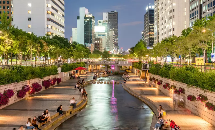 People relaxing by Cheong-Gyecheon stream in the centre of Seoul on a summer evening