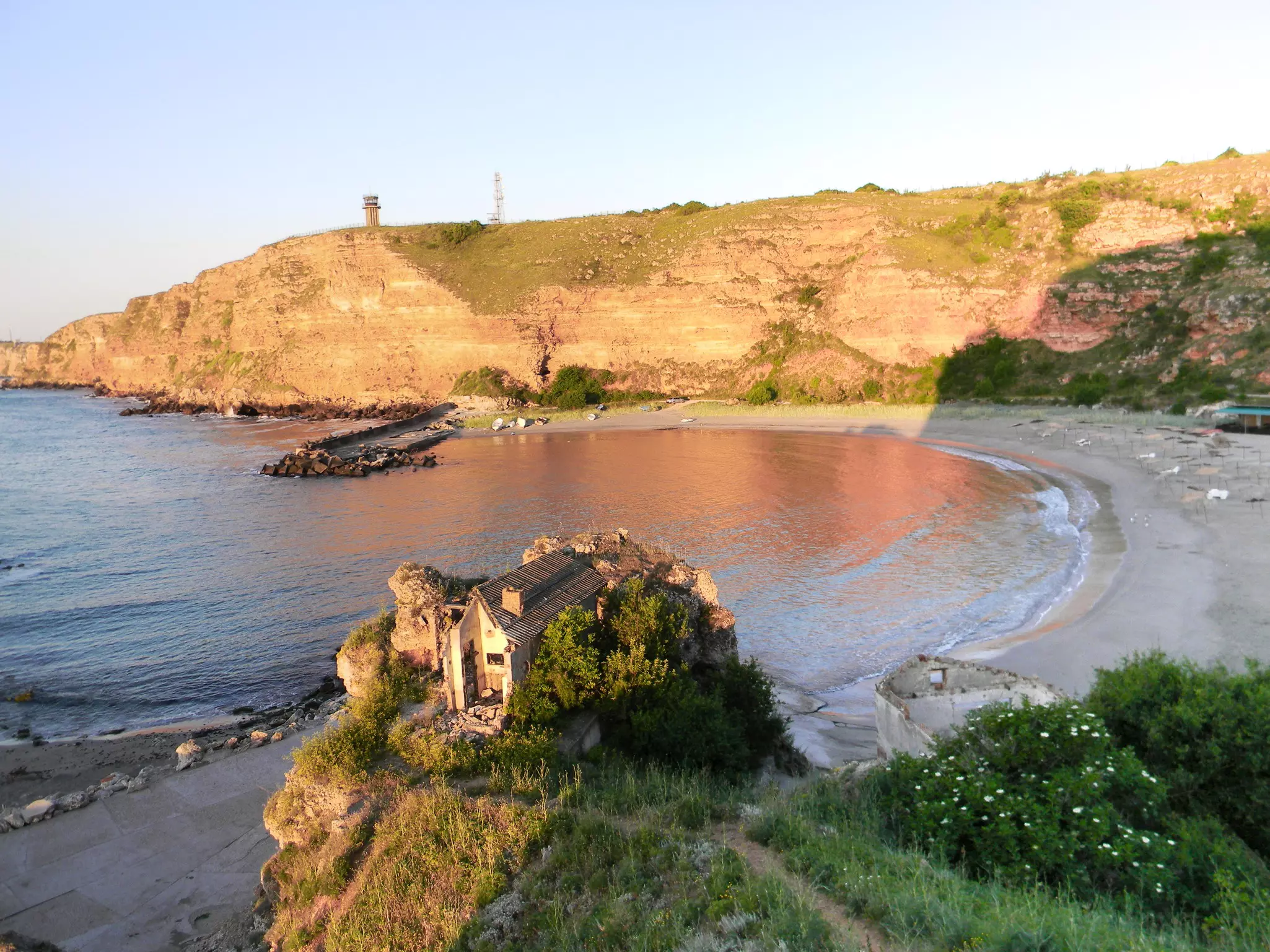 Morning at Bolata Bay, Varna province, Bulgaria. Destroyed house on the beach in sun light