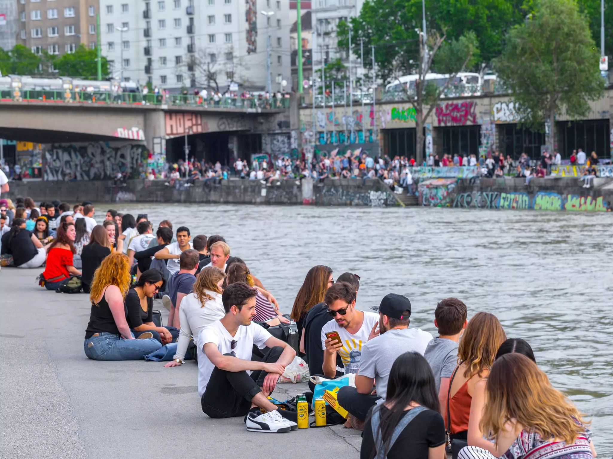 VIENNA, AUSTRIA - MAY 25: Many people are relaxing with alcohol drinks on a day off in a beautiful summer weather on the banks of the Danube Canal(Donaukanal) in Vienna, Austria, on May 25, 2019.