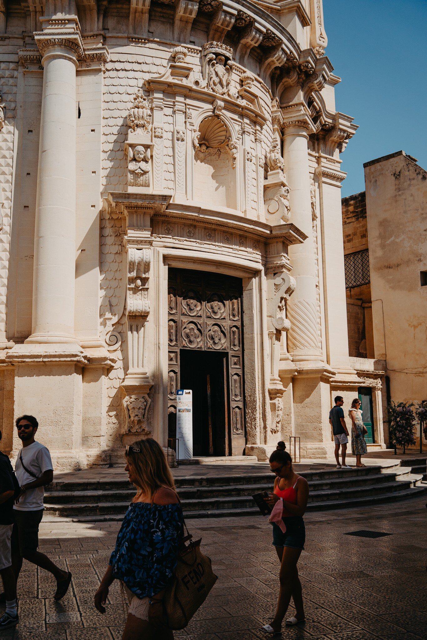 Tourists walk past the Church of San Matteo.