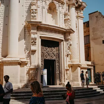 Tourists walk past the Church of San Matteo.