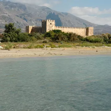 The Frangokastello Castle, with glimmering clear water in the foreground in Crete, Greece.