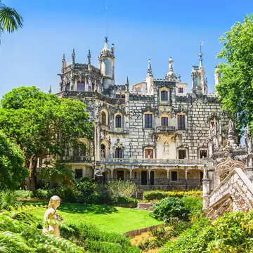 Exterior view of the Quinta da Regaleira on a sunny day in Sintra, Portugal.
