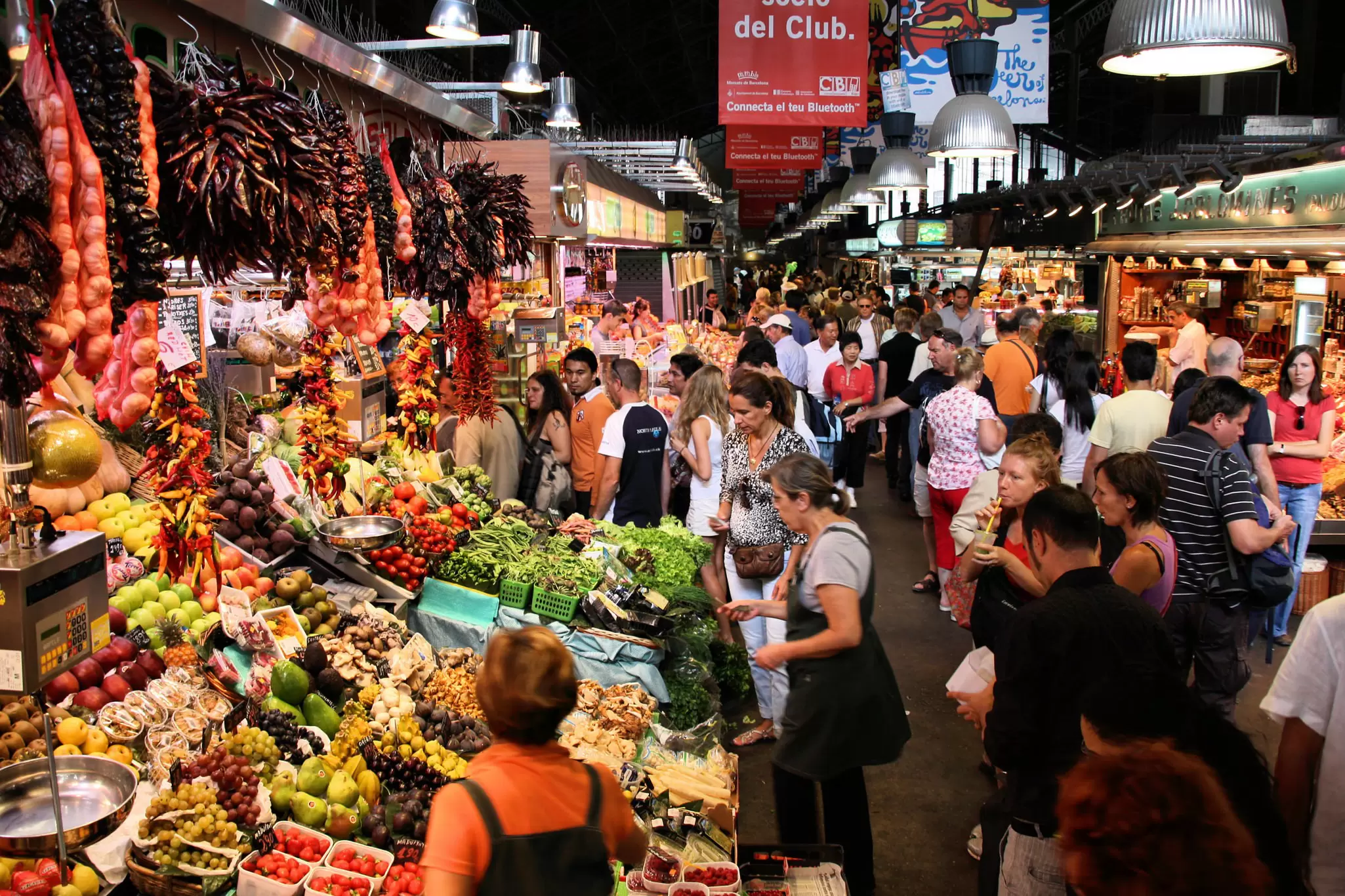 Tourists filling the aisles at the famous La Boqueria market in Barcelona.