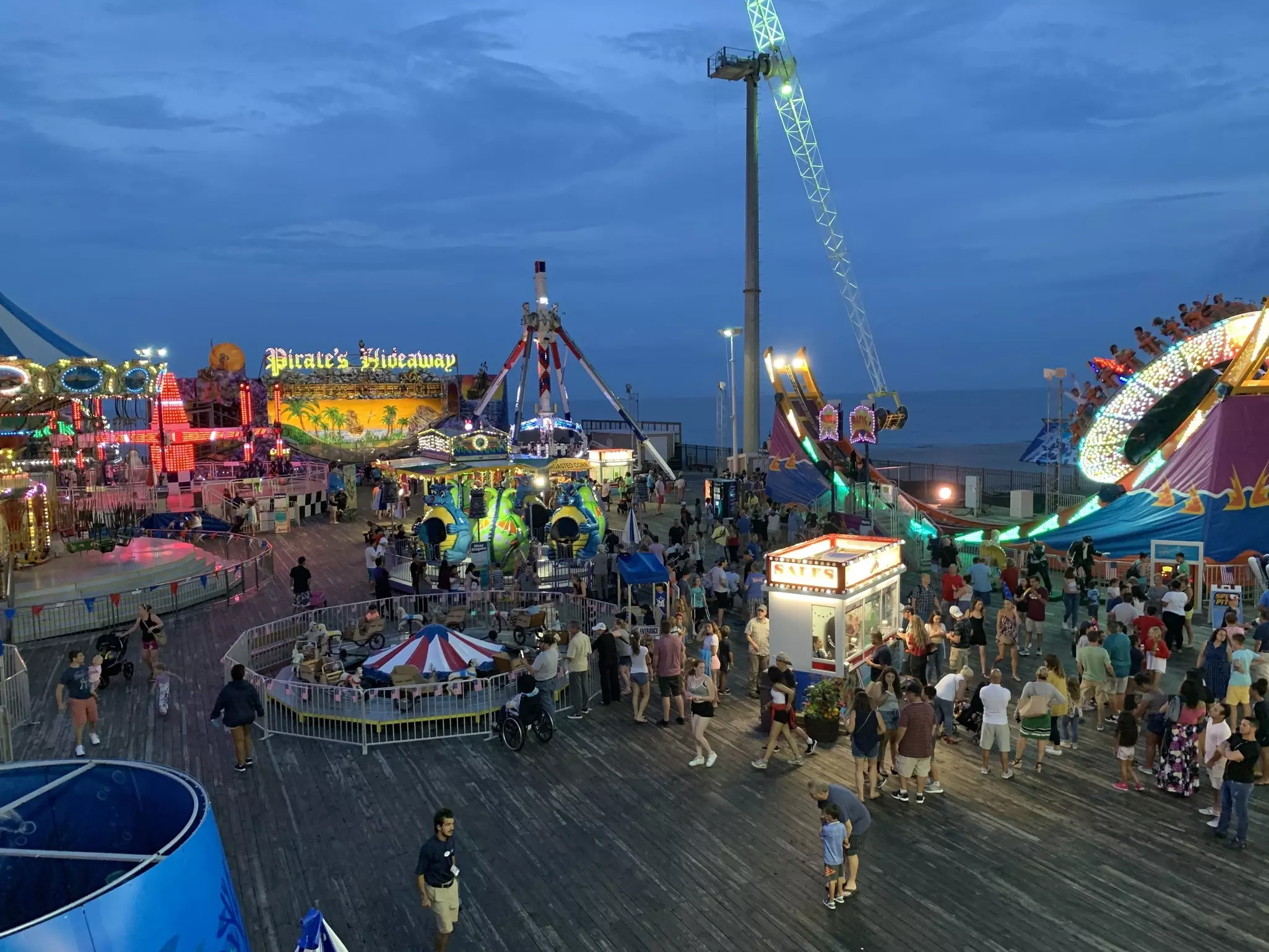 People enjoy the rides at an amusement park on a summer night on the Jersey Shore boardwalk of Seaside Heights, New Jersey.