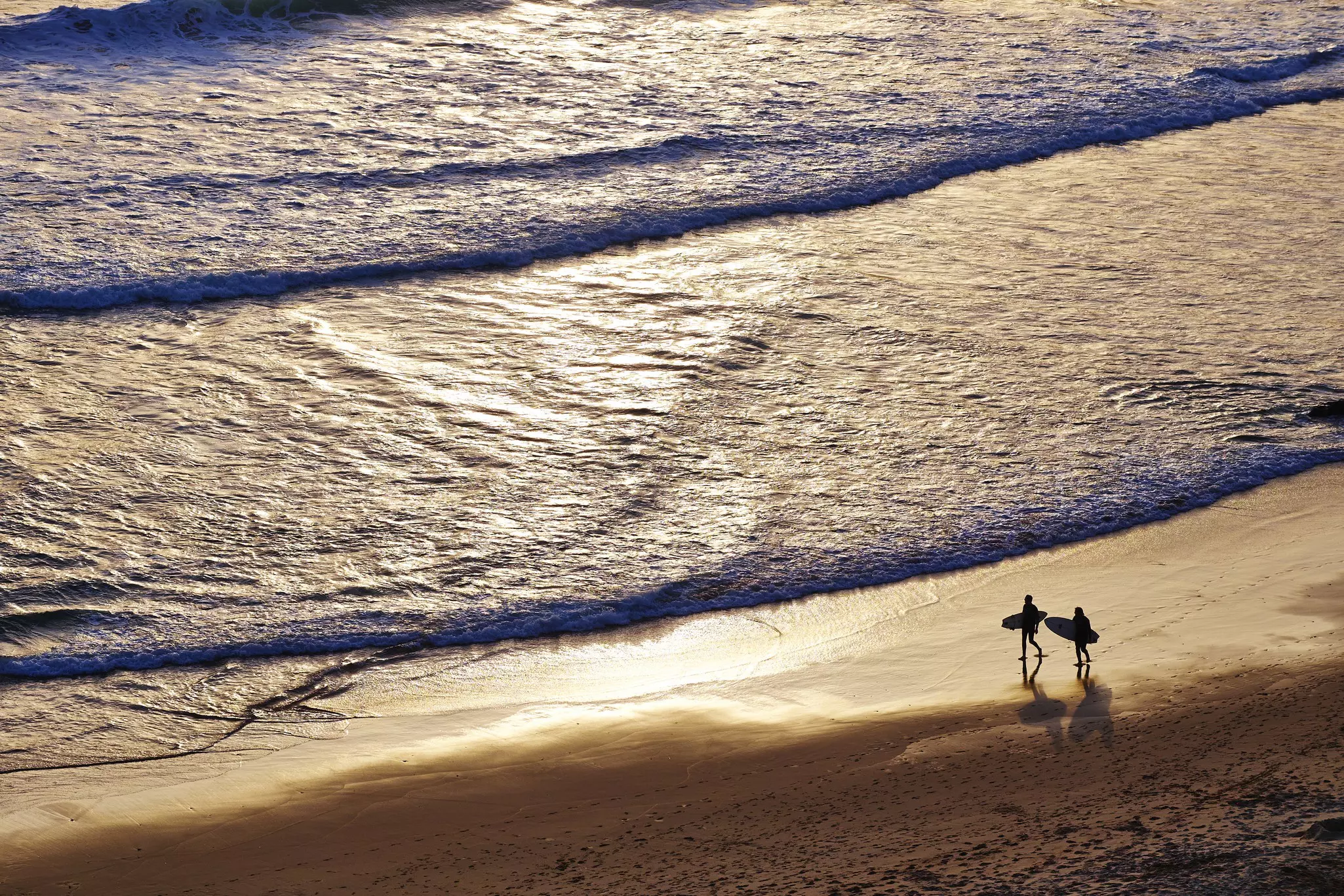 Surfers on the shore at Beliche beach, the Algarve.