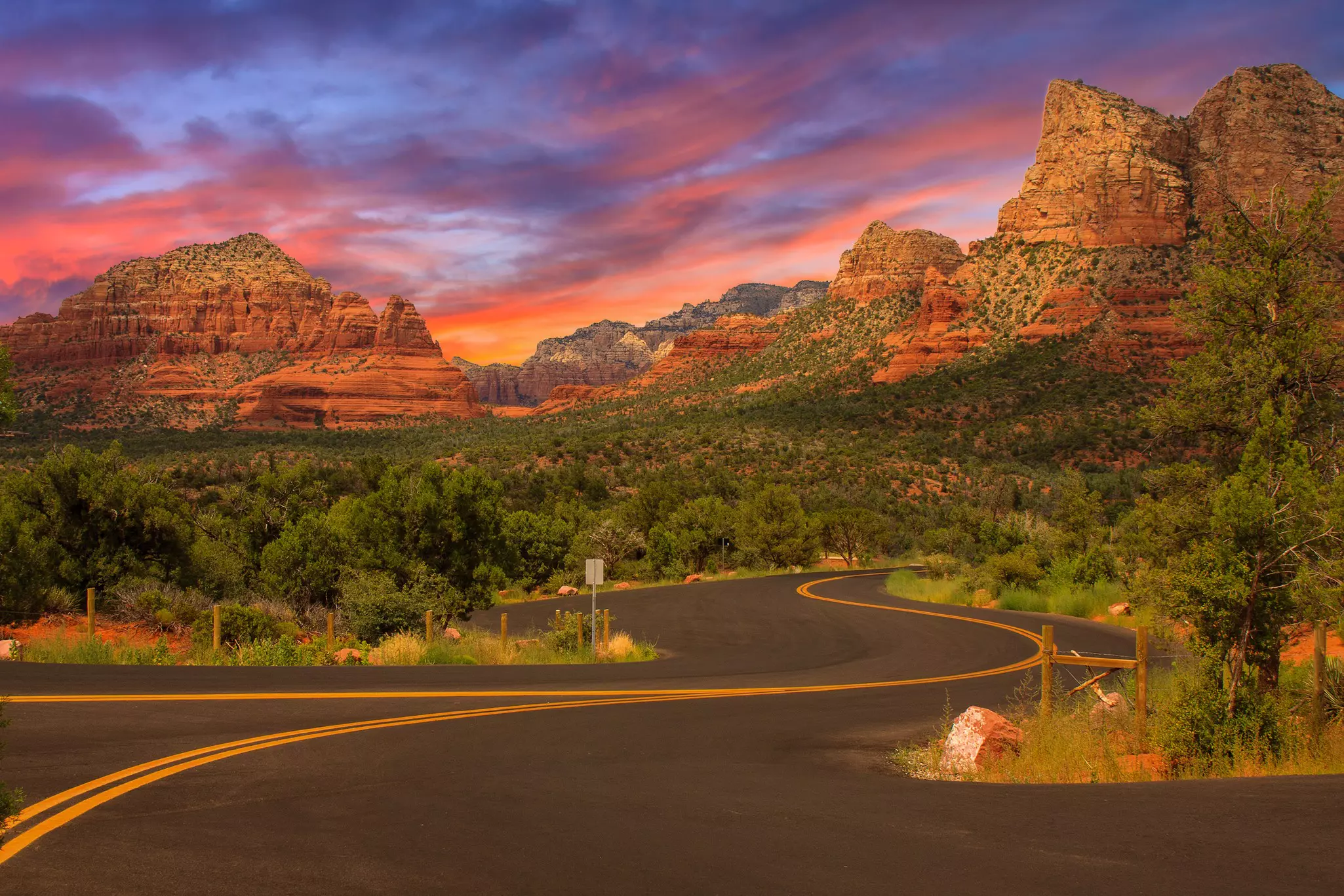 Curve through and around the awe-inspiring sandstone rocks along the Red Rock Scenic Byway (State Route 179)