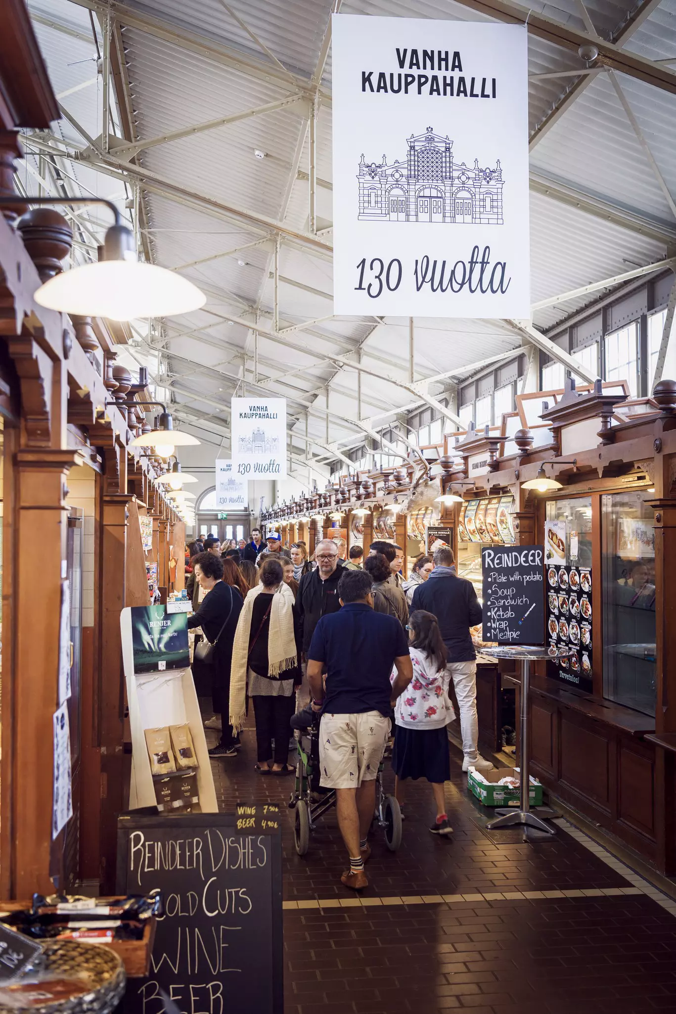 Shoppers in a covered market, Vanha Kauppahalli in Helsinki