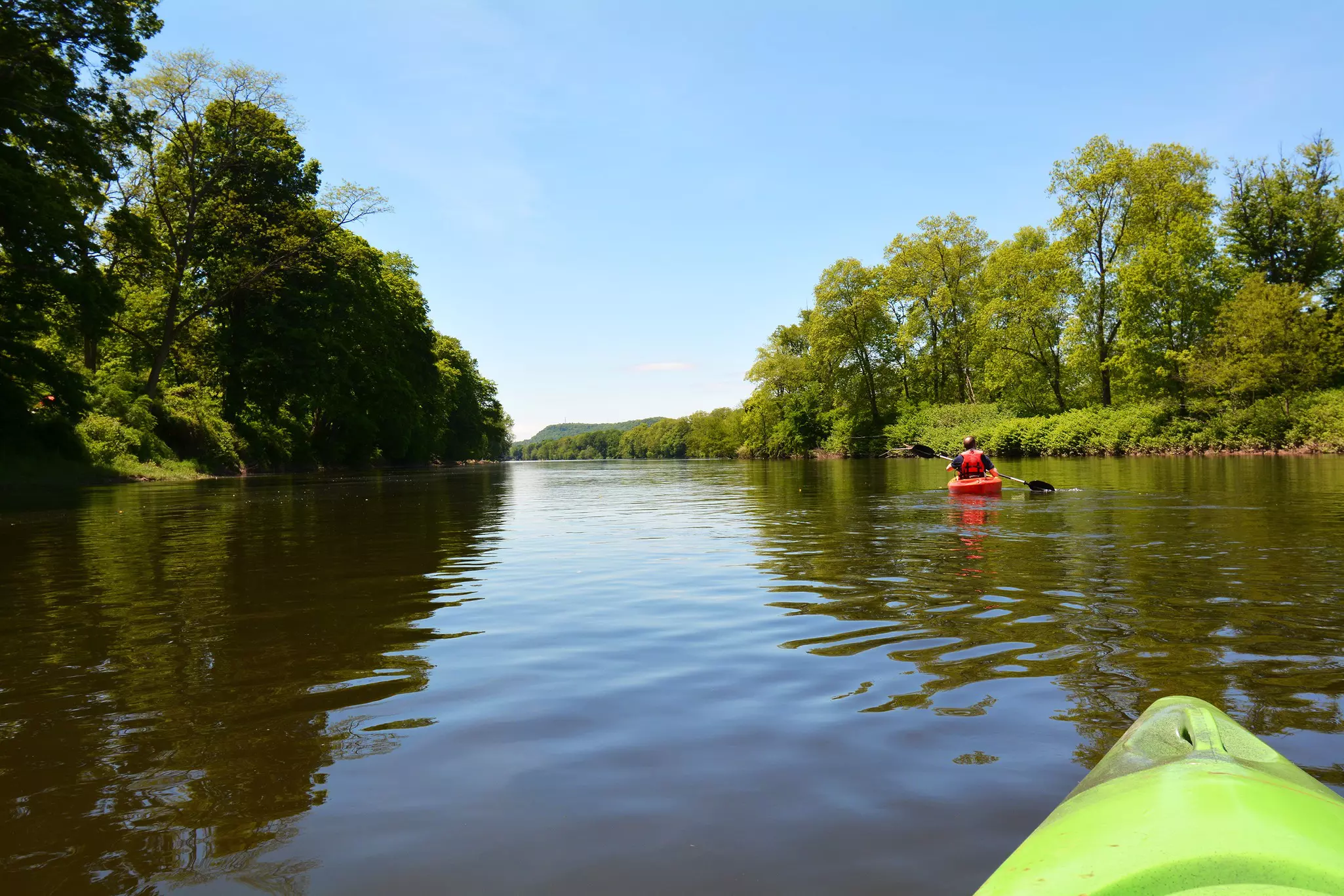 A person kayaking on the Delaware River near the Delaware Water Gap