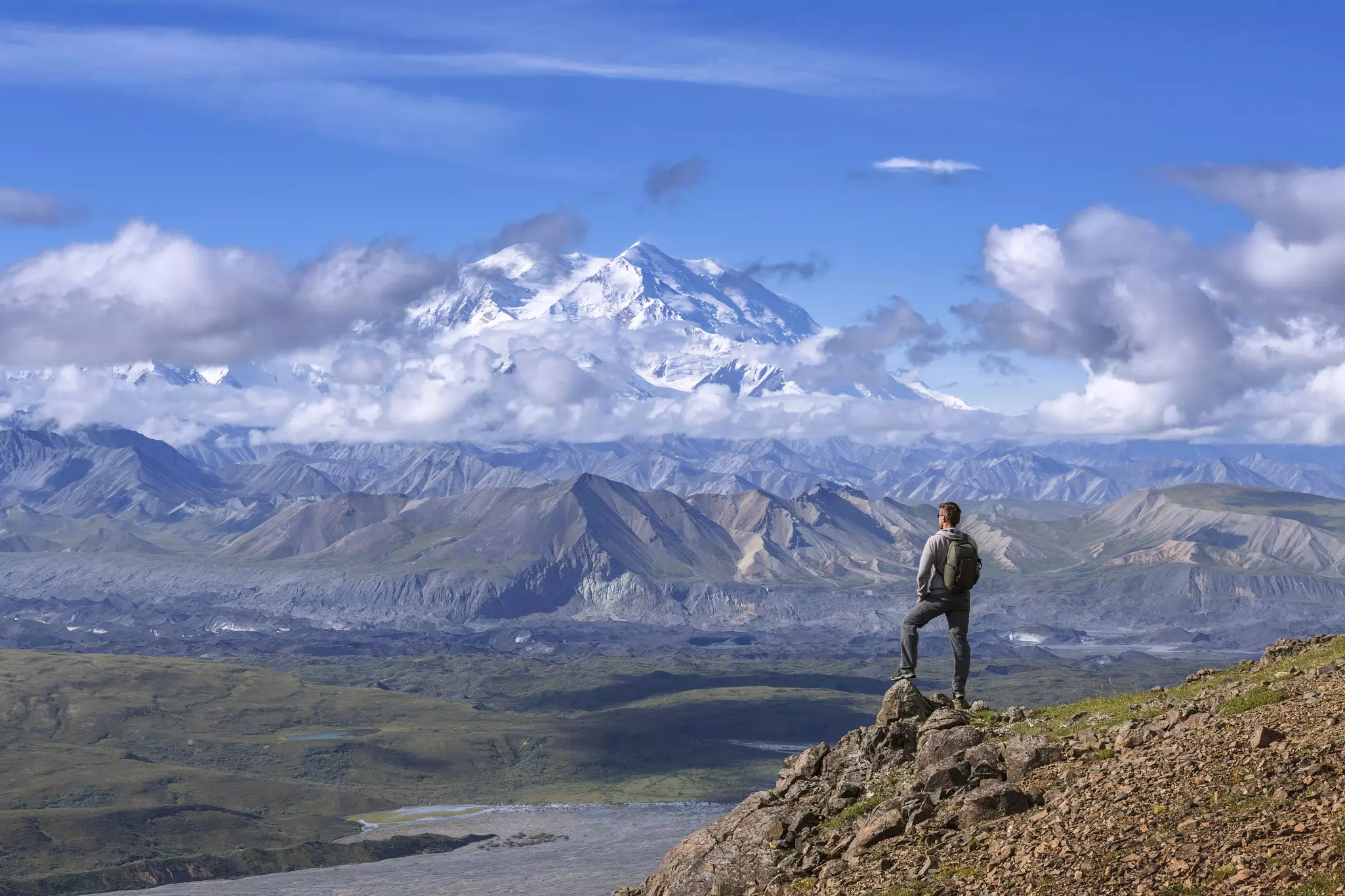 A lone hiker stands looking across at Denali, the tallest mountain in North America © Shutterstock / sunsinger