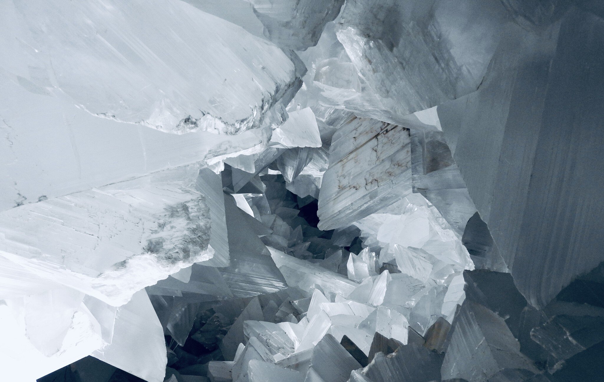 Geometric shapes of a large white crystal in a cave.