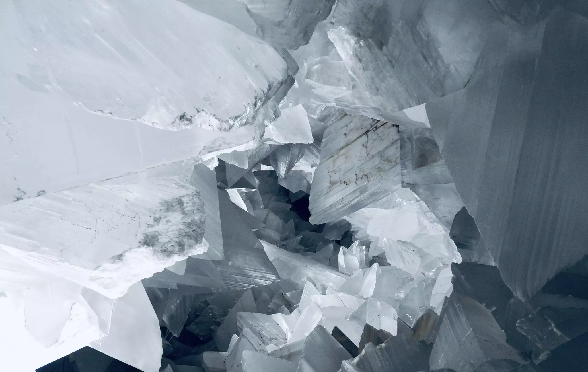 Geometric shapes of a large white crystal in a cave.
