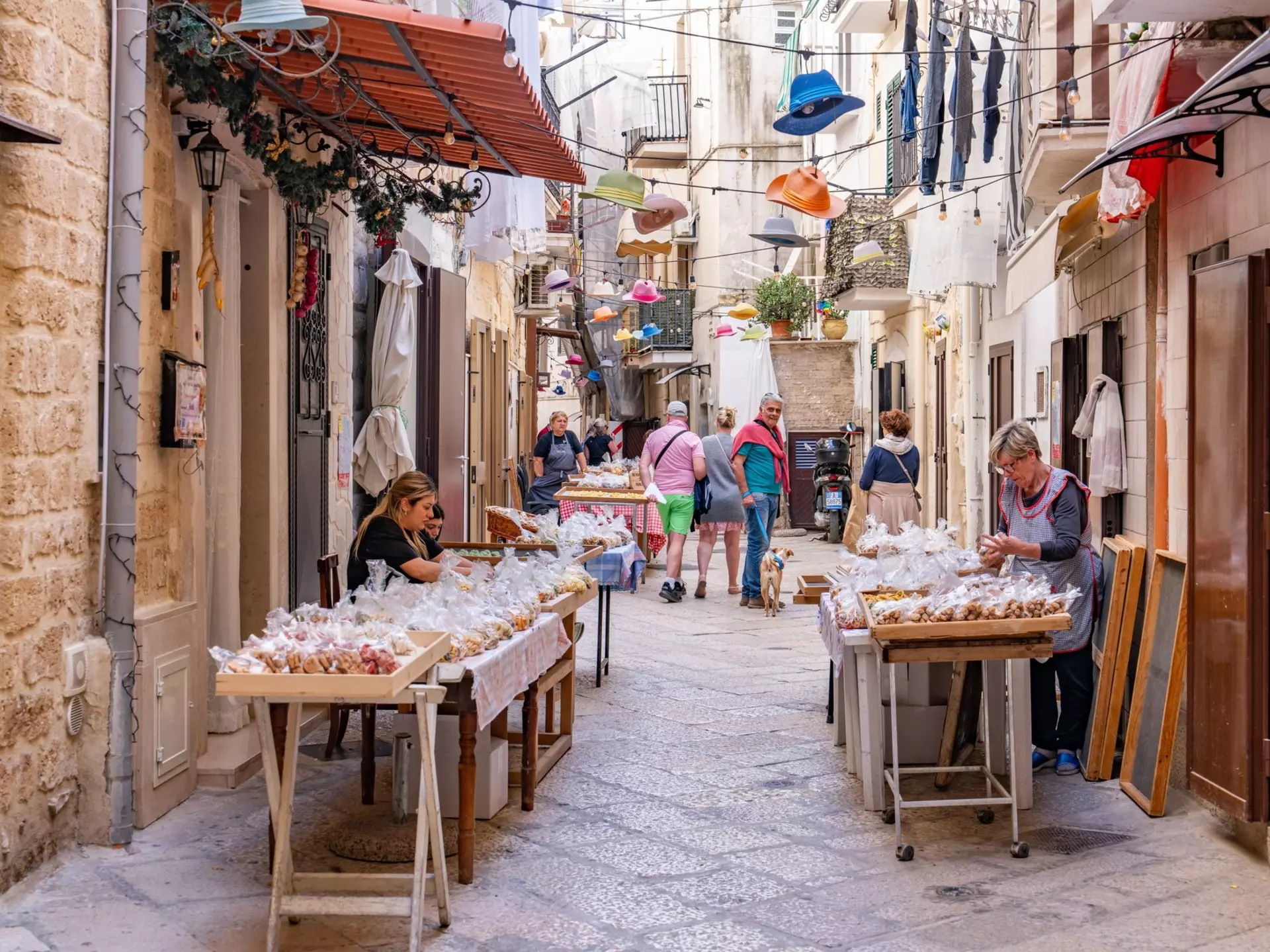 Local women selling authentic hand made pasta in the old town of Bari, Italy