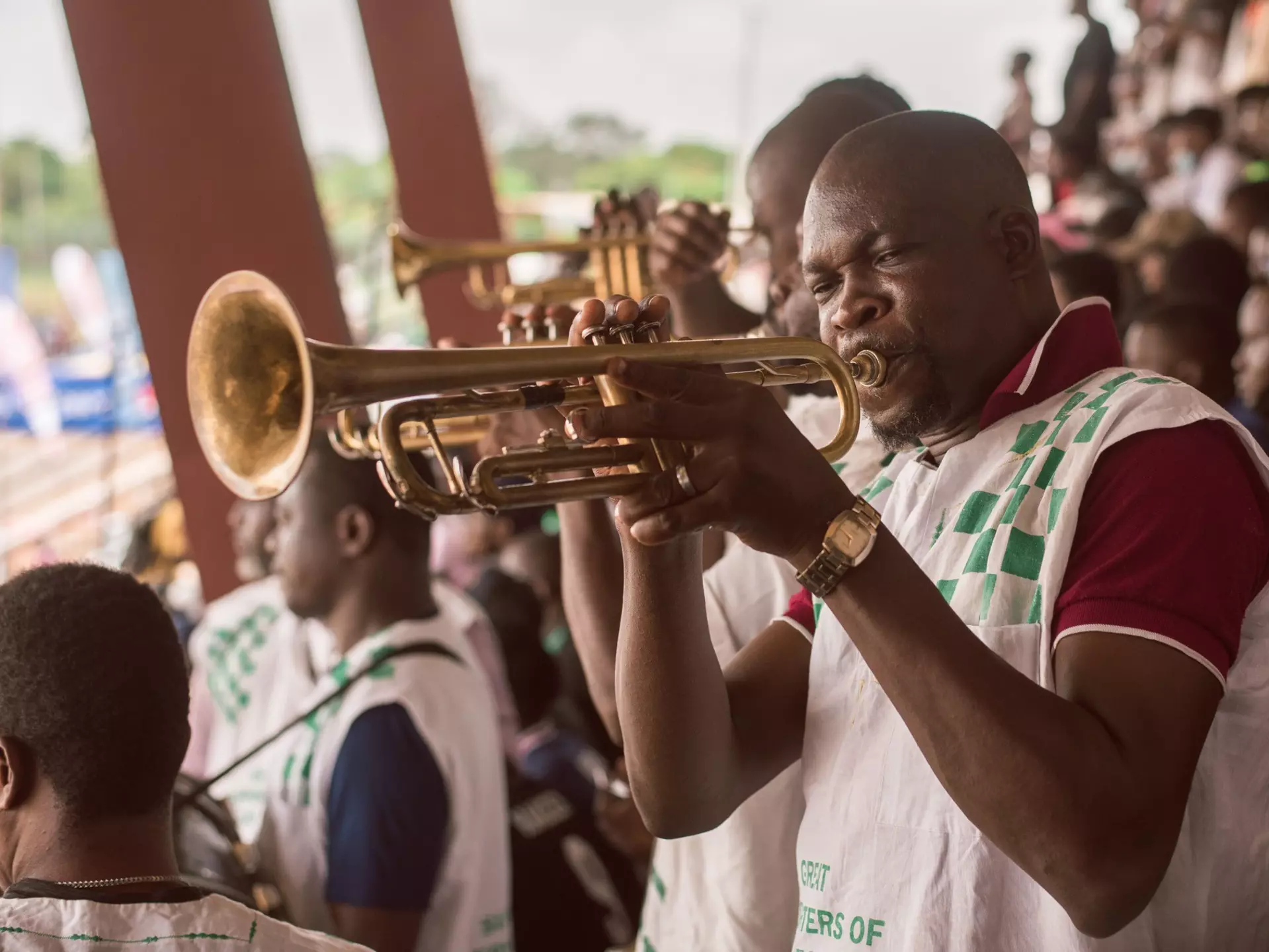 A band member blowing the trumpet during a football game at the Nigerian University games at the University of Lagos