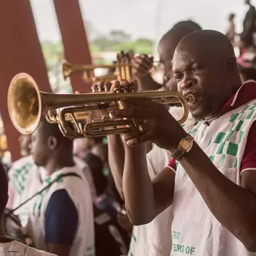 A band member blowing the trumpet during a football game at the Nigerian University games at the University of Lagos