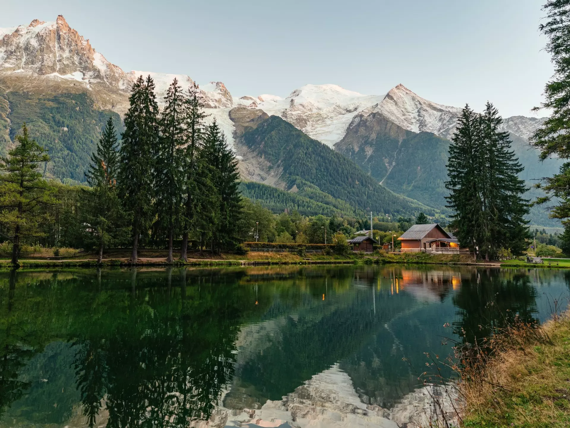 Beautiful view of Lac des Gaillands with Mont Blanc massif and wooden chalet in Chamonix town at French Alps, Savoie, France. 