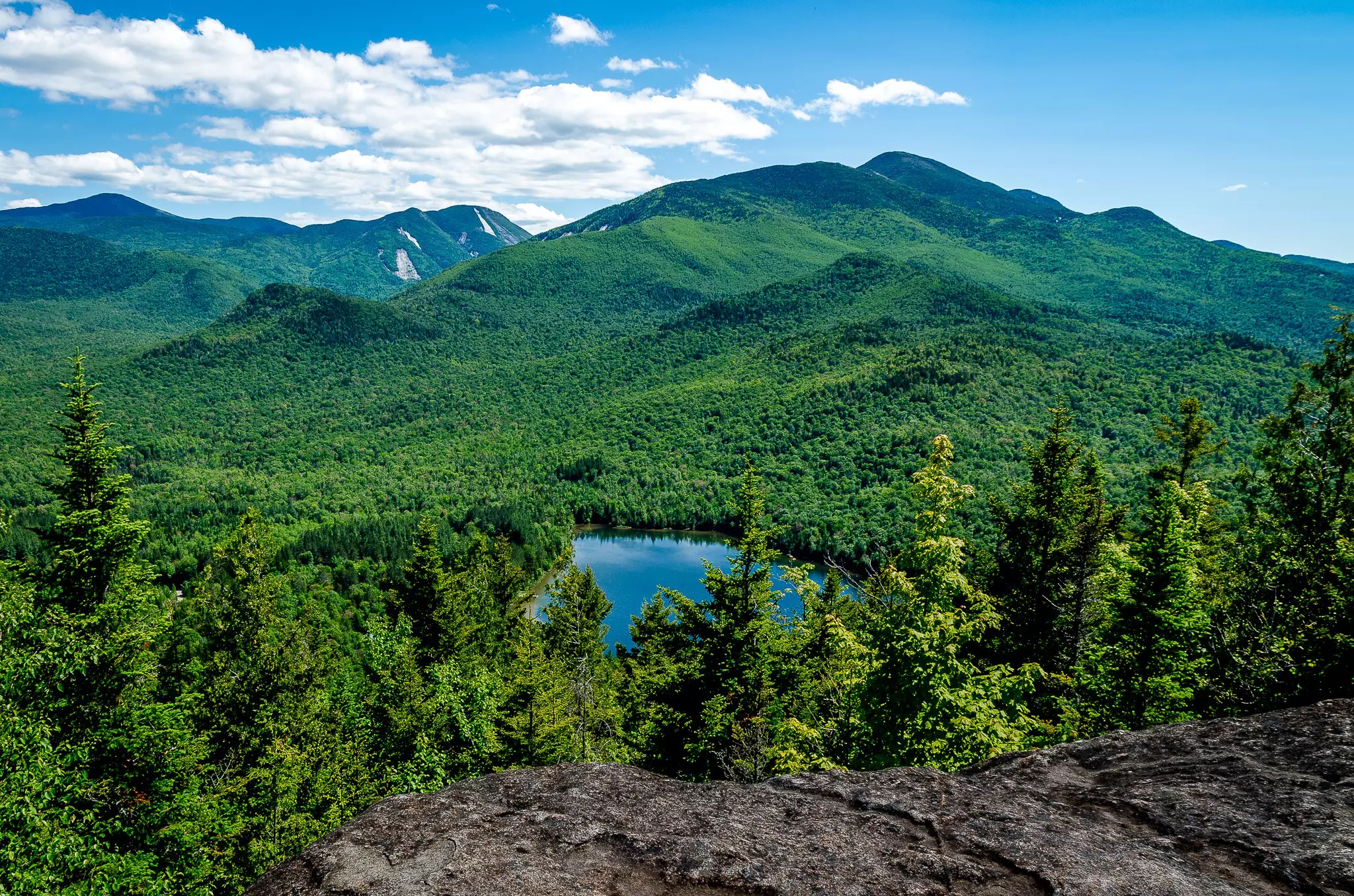View of green mountains and a small lake